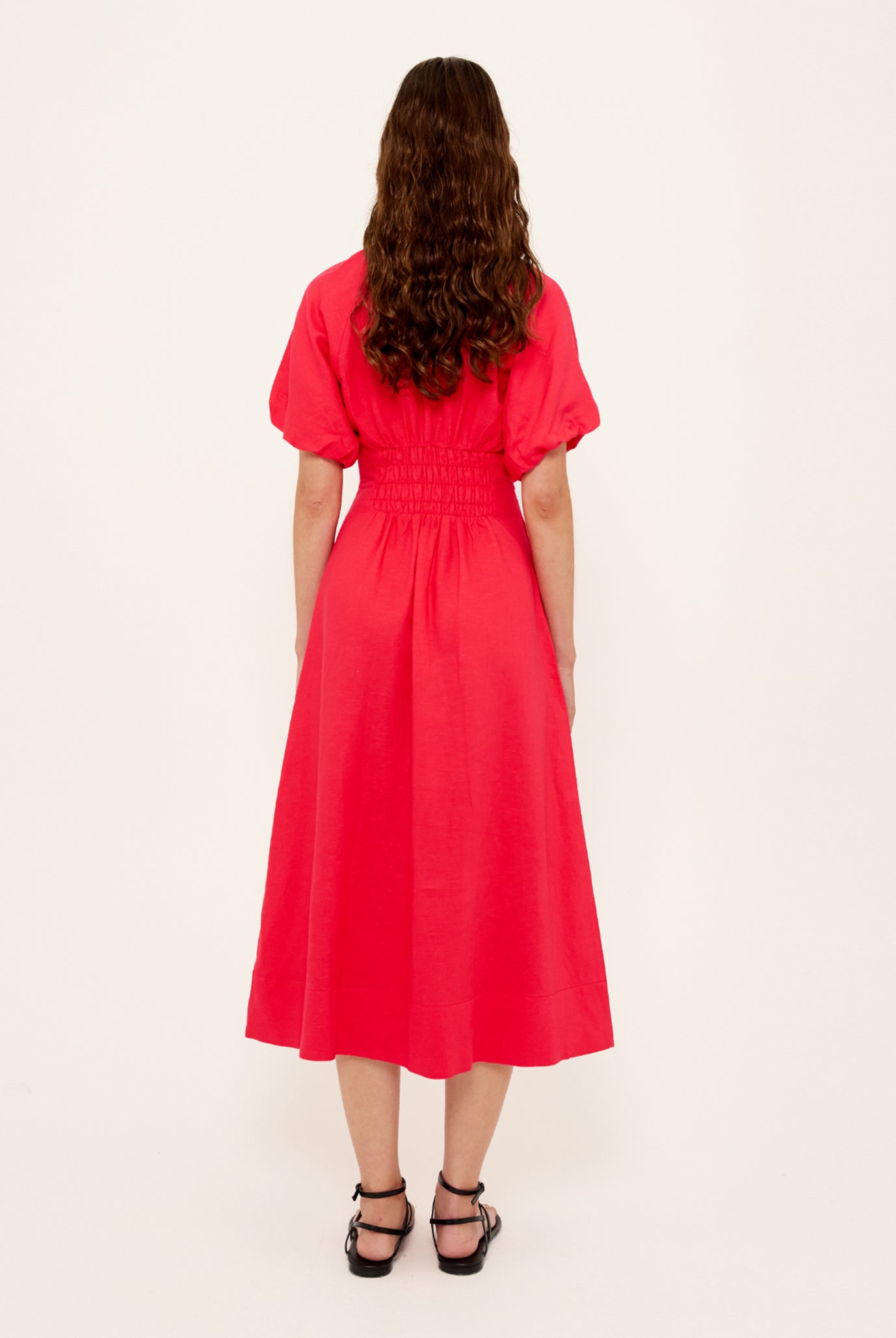 Person wearing a red dress on a white background