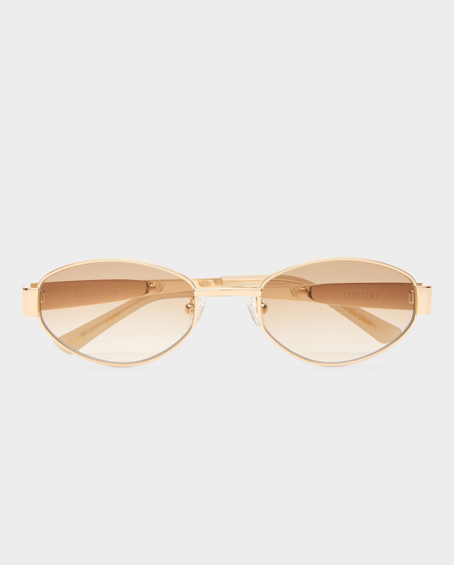 Gold sunglasses with a reflective surface on a white background