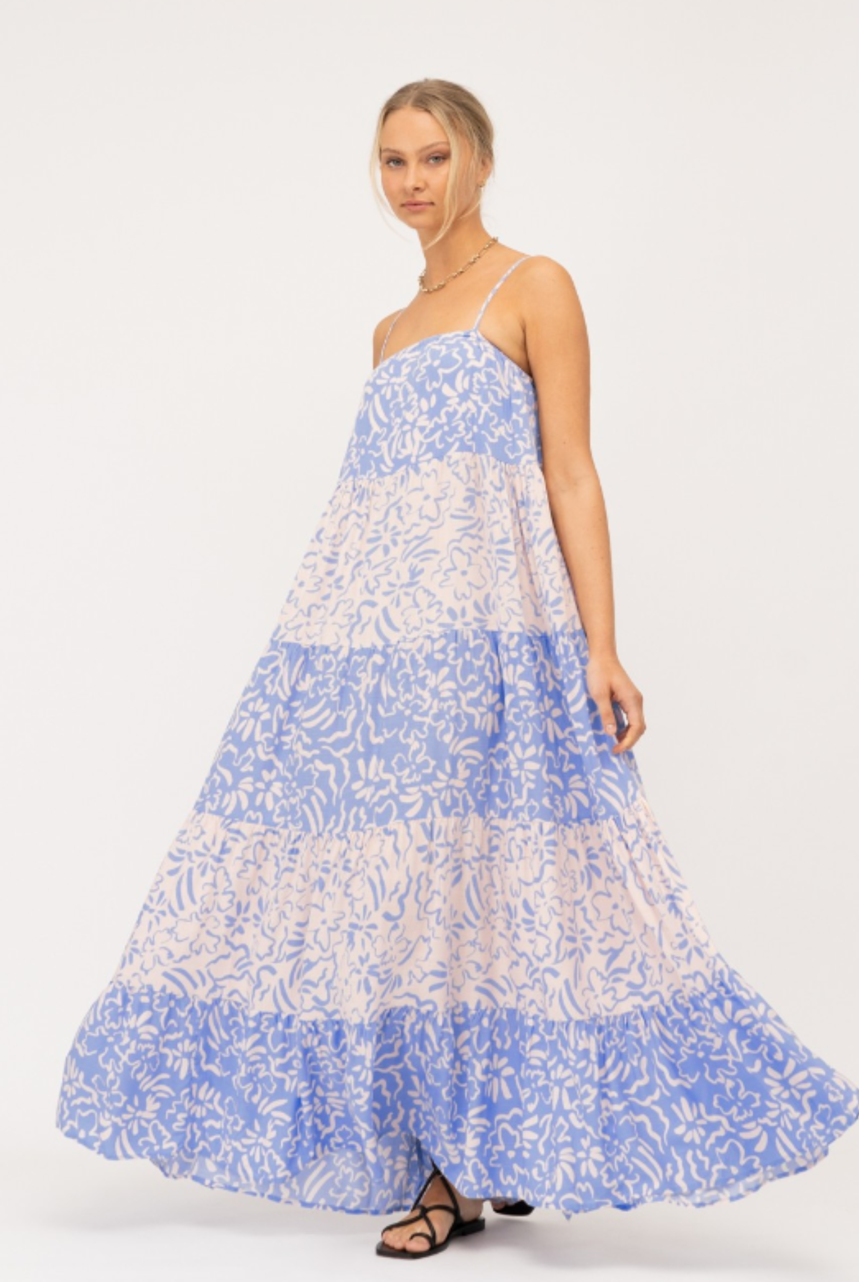 Model wearing tiered Livia Maxi Dress in blue and white mixed media print
