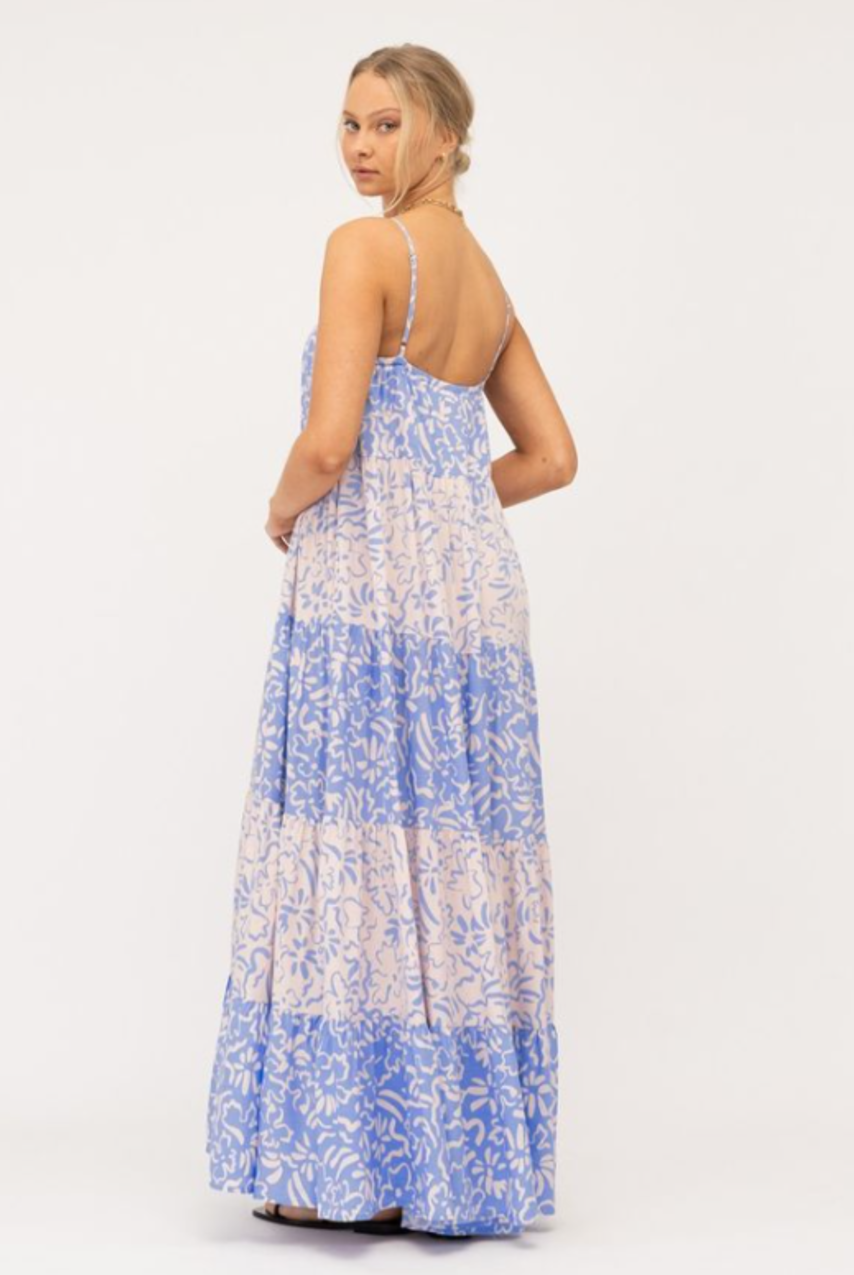 Model wearing tiered Livia Maxi Dress in blue and white mixed media print