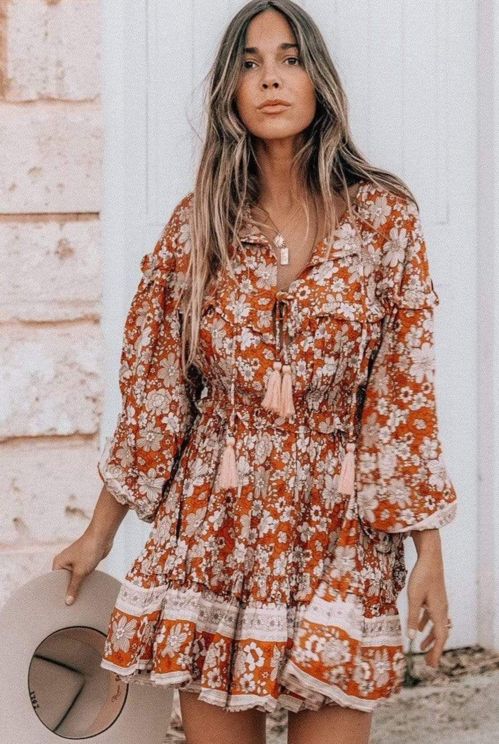 Model wearing floral print boho mini dress