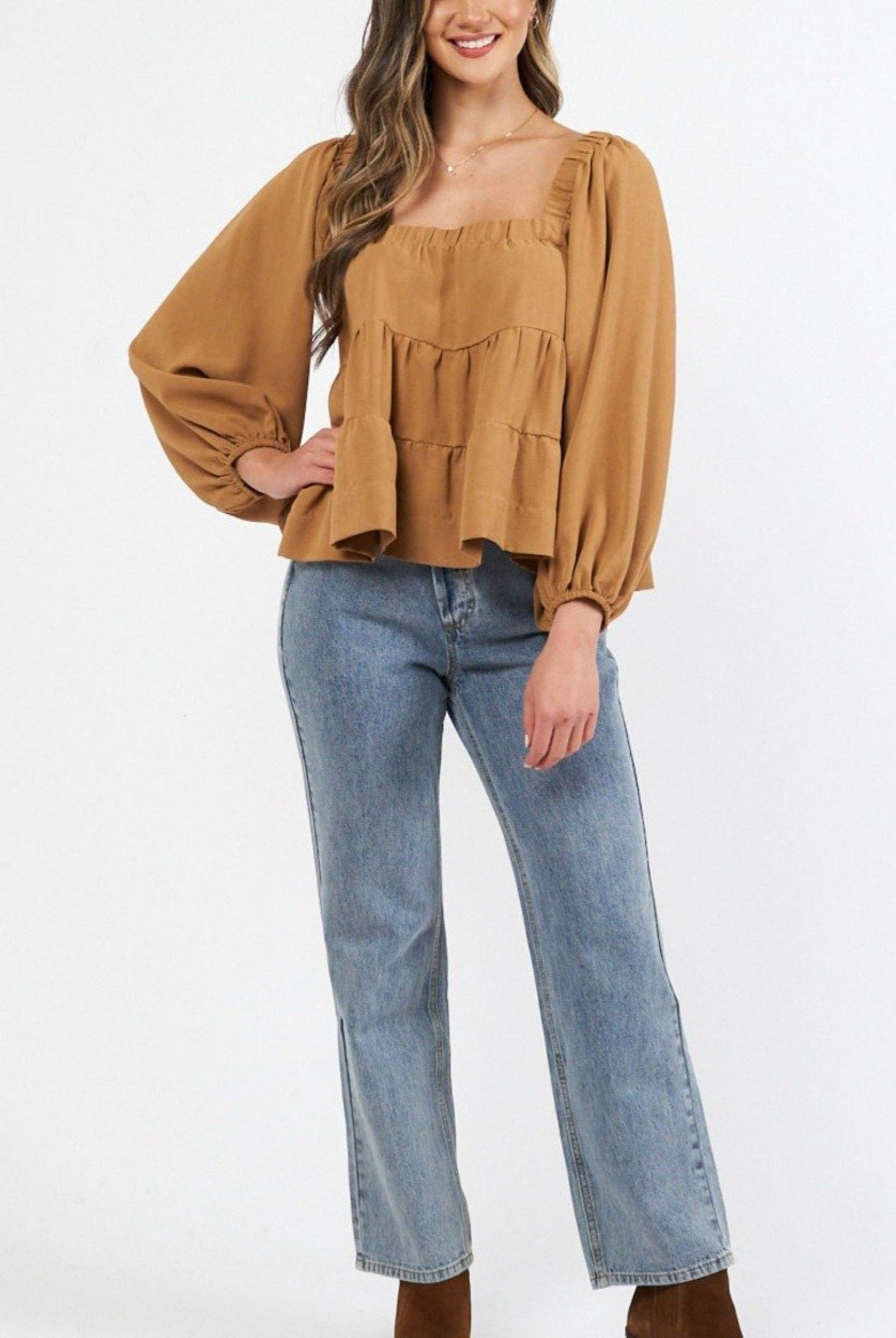 Woman wearing cinnamon colour trapeze top
