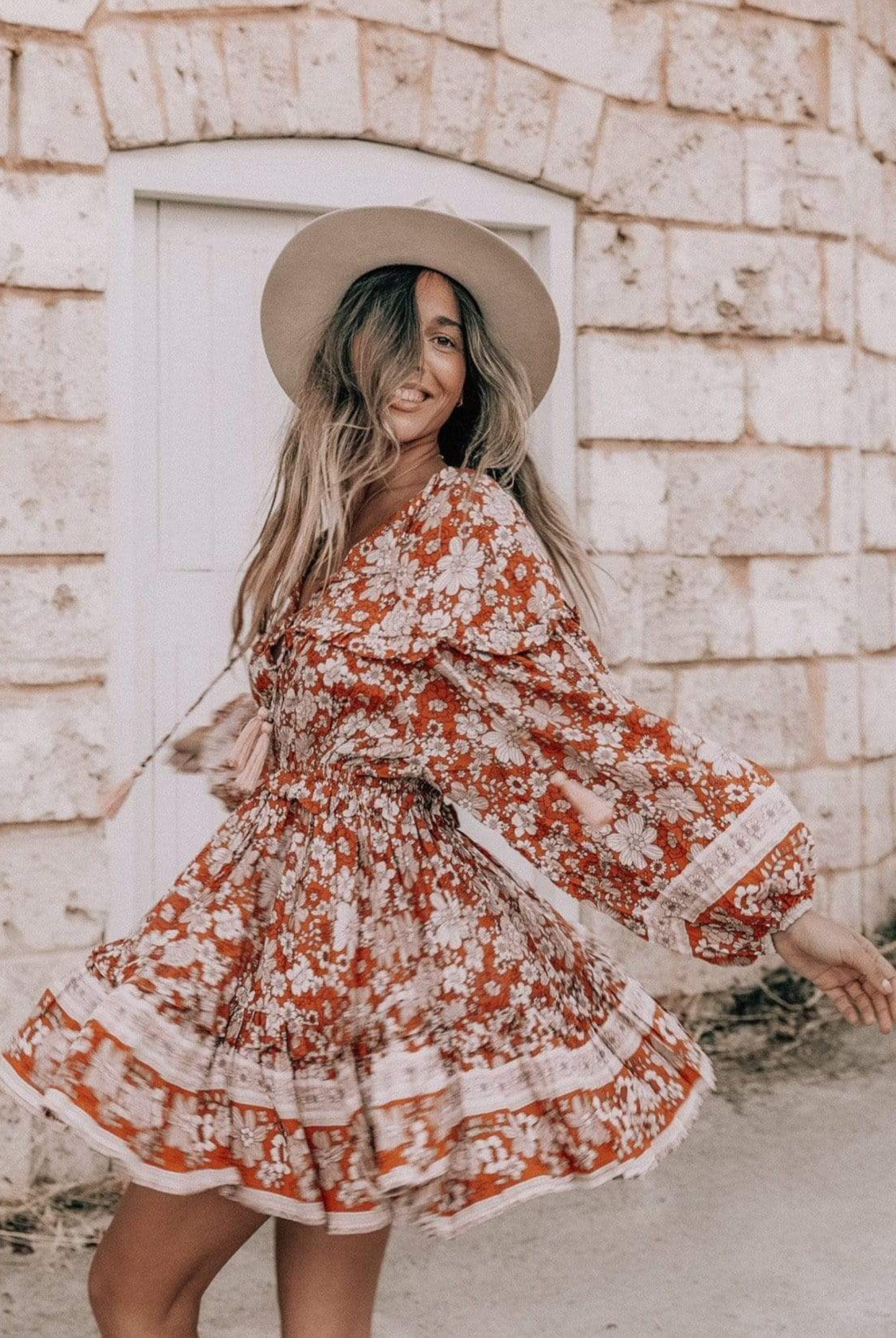 Model wearing floral print boho mini dress