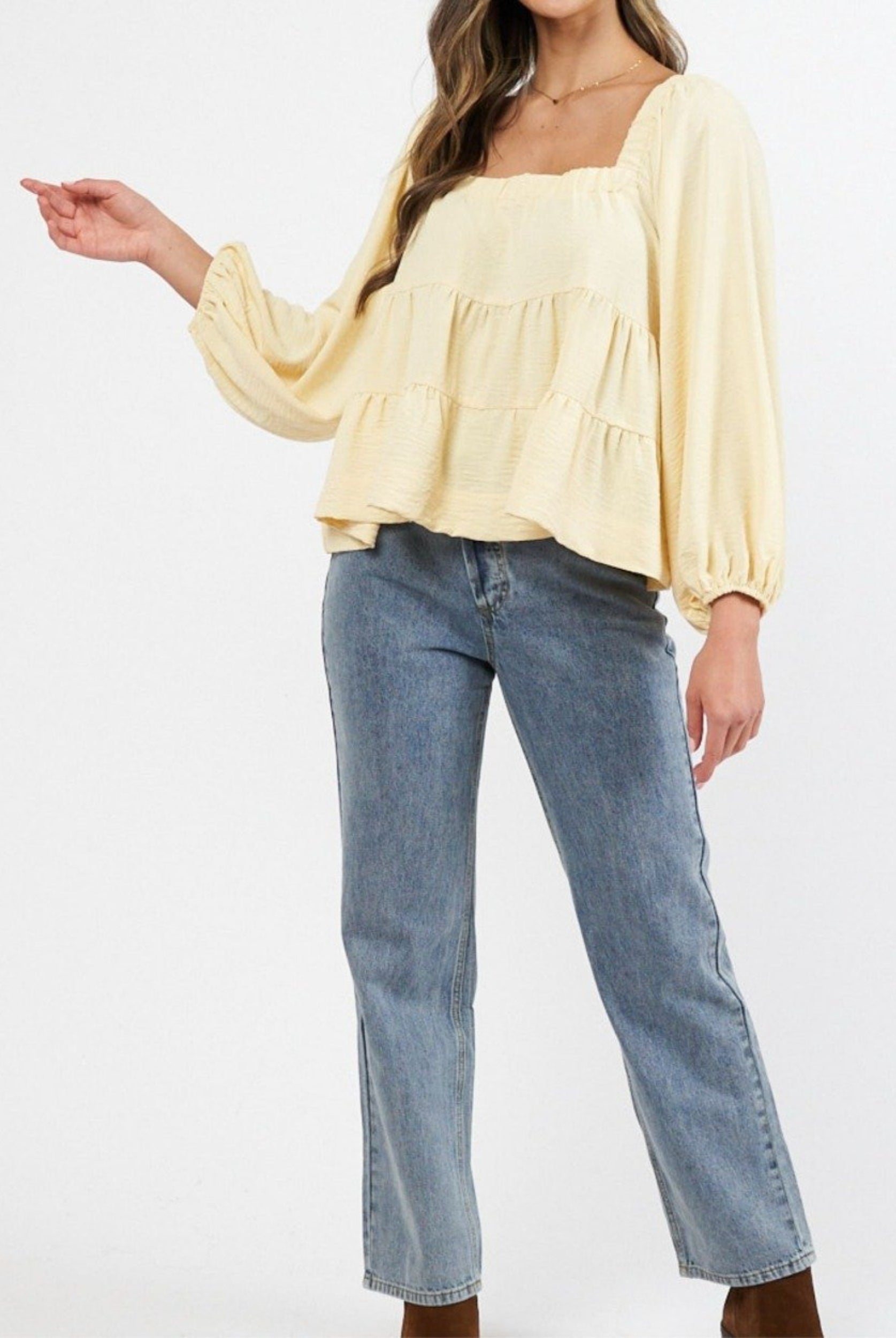 Model wearing a yellow top