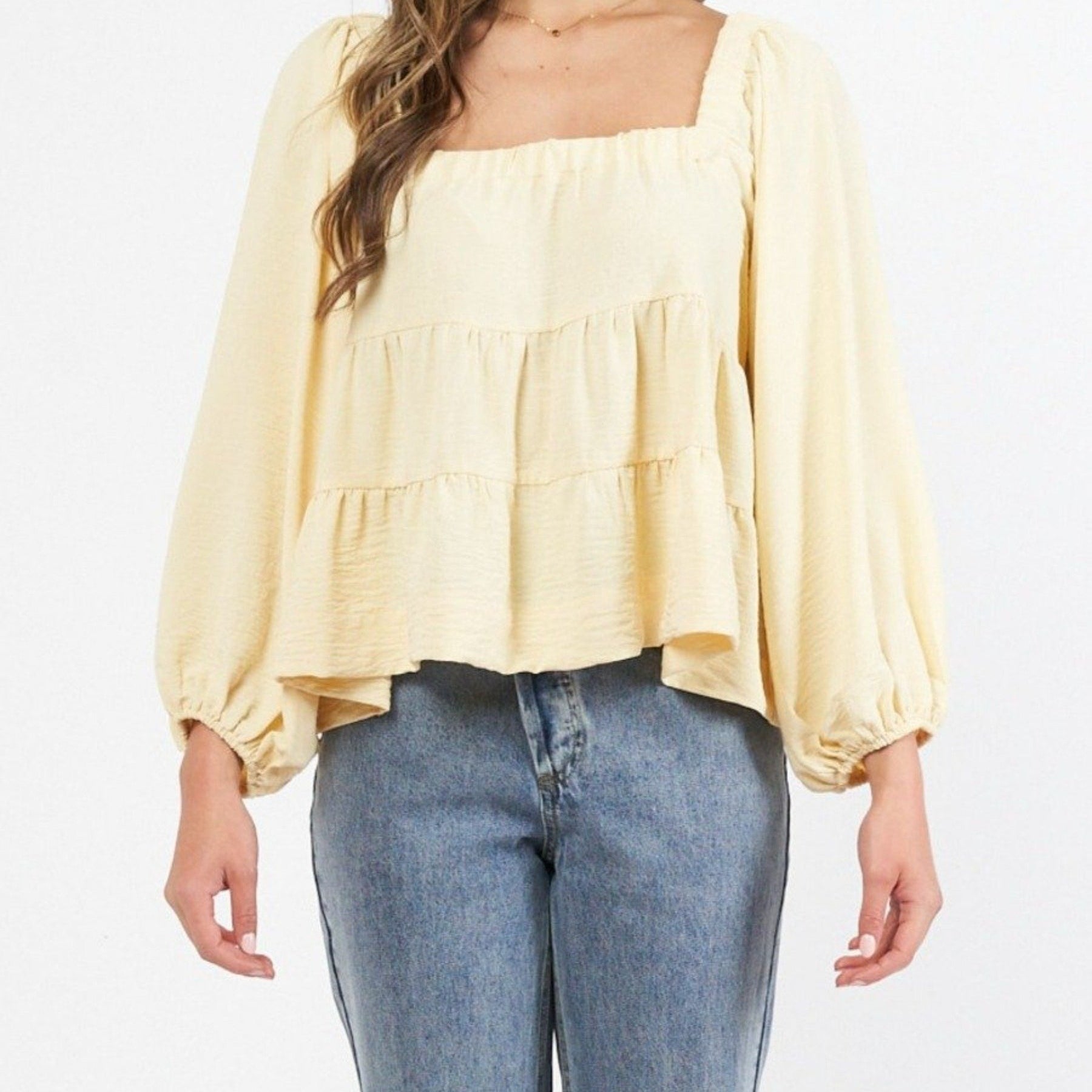 Model wearing a yellow top