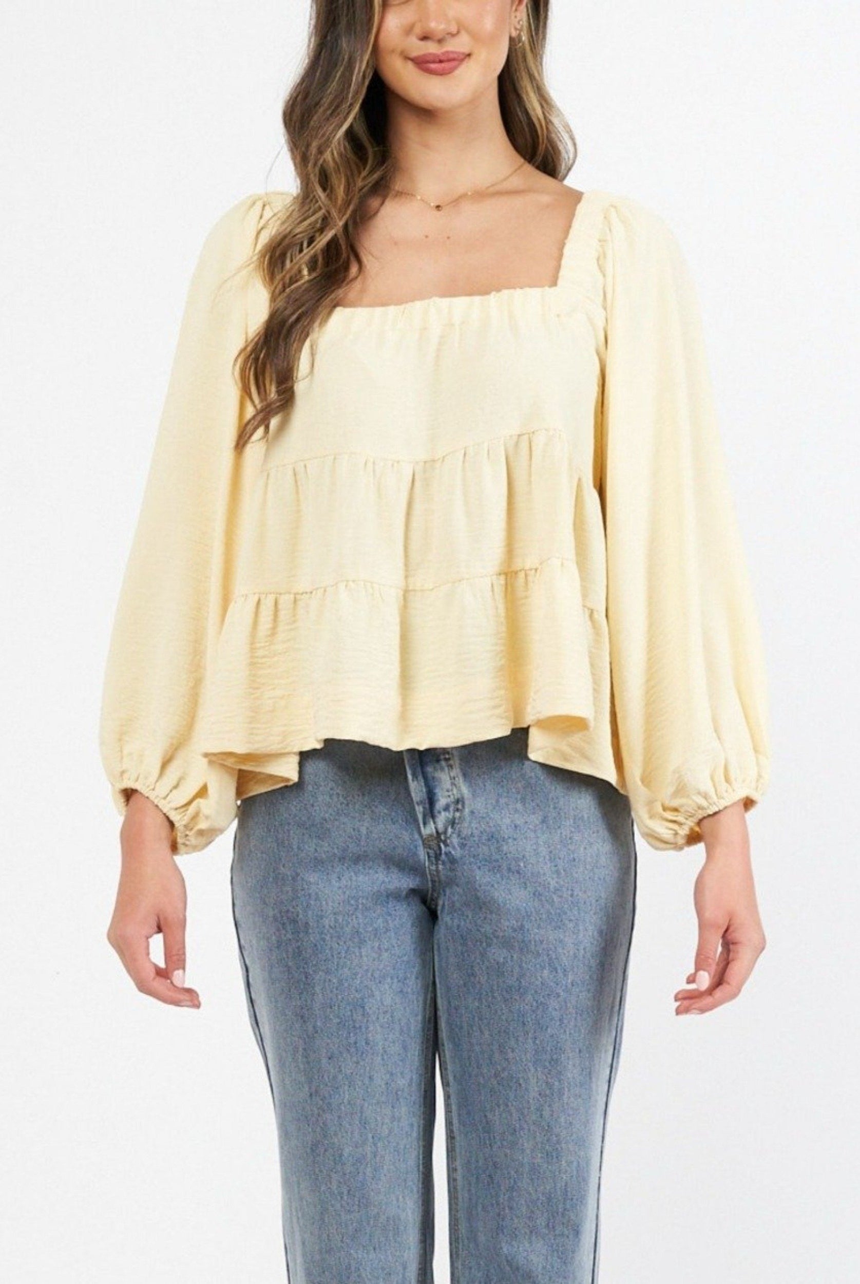 Model wearing a yellow top