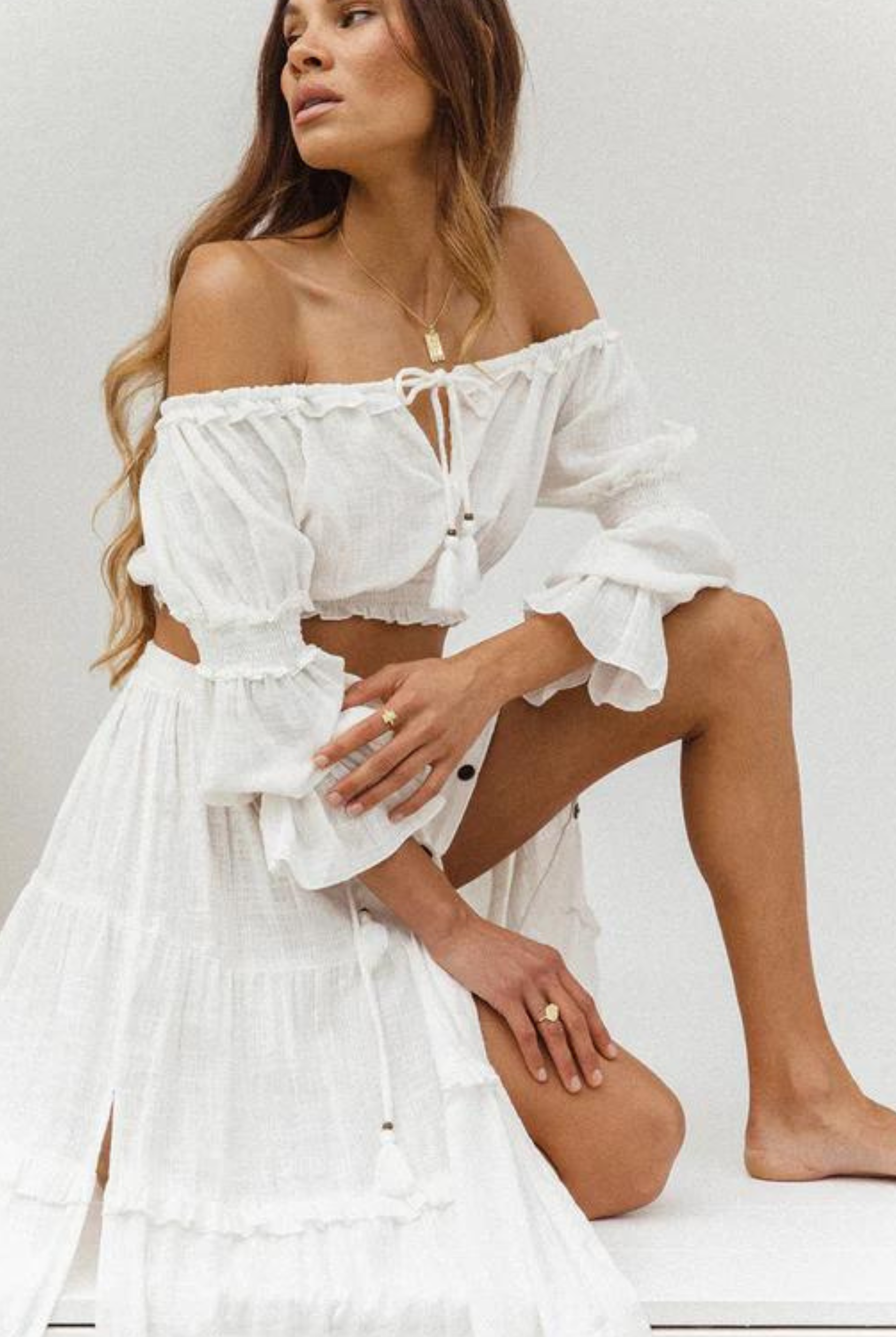 Model wearing a cotton maxi skirt with button through front and tiered design skirt