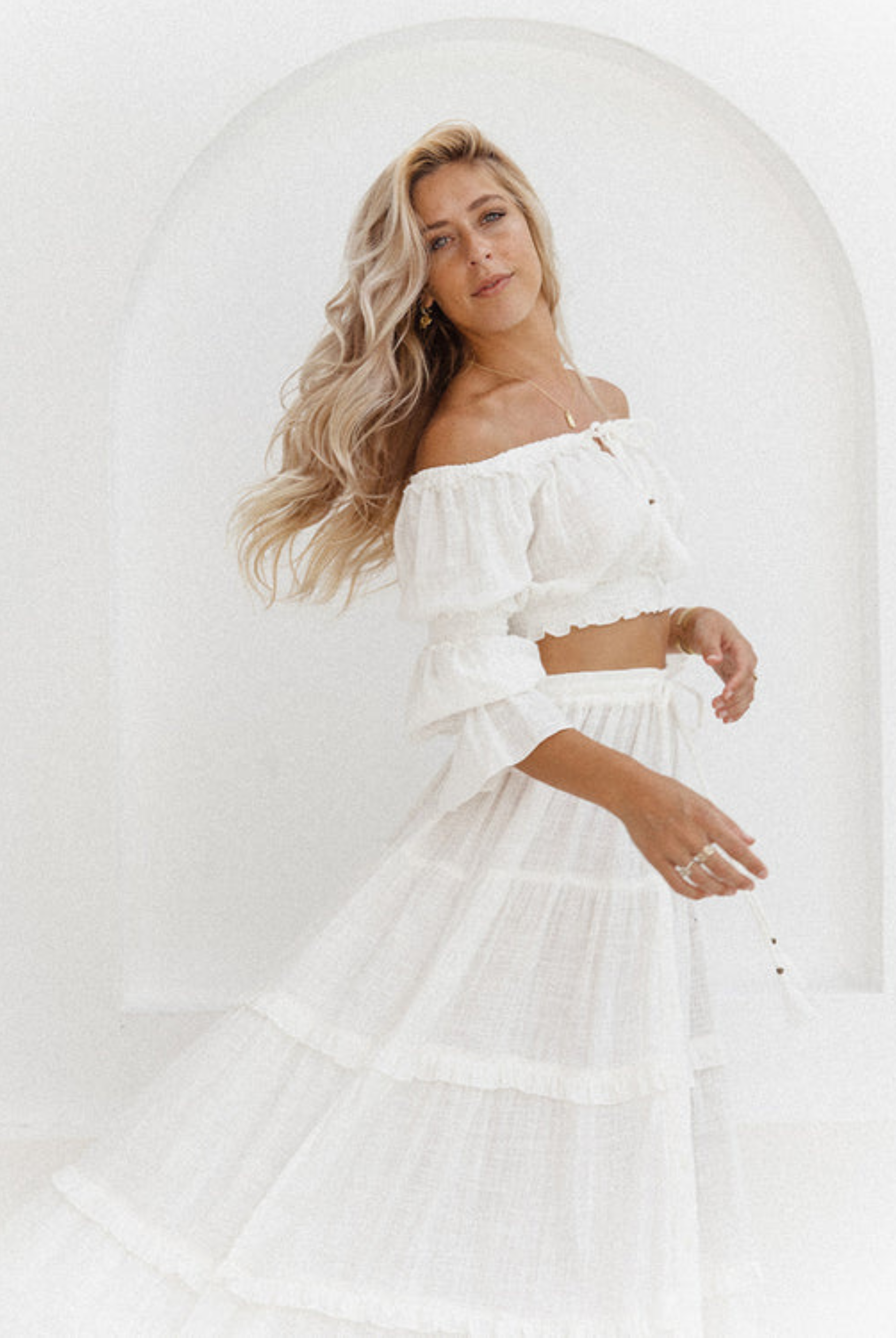 Model wearing a cotton maxi skirt with button through front and tiered design skirt