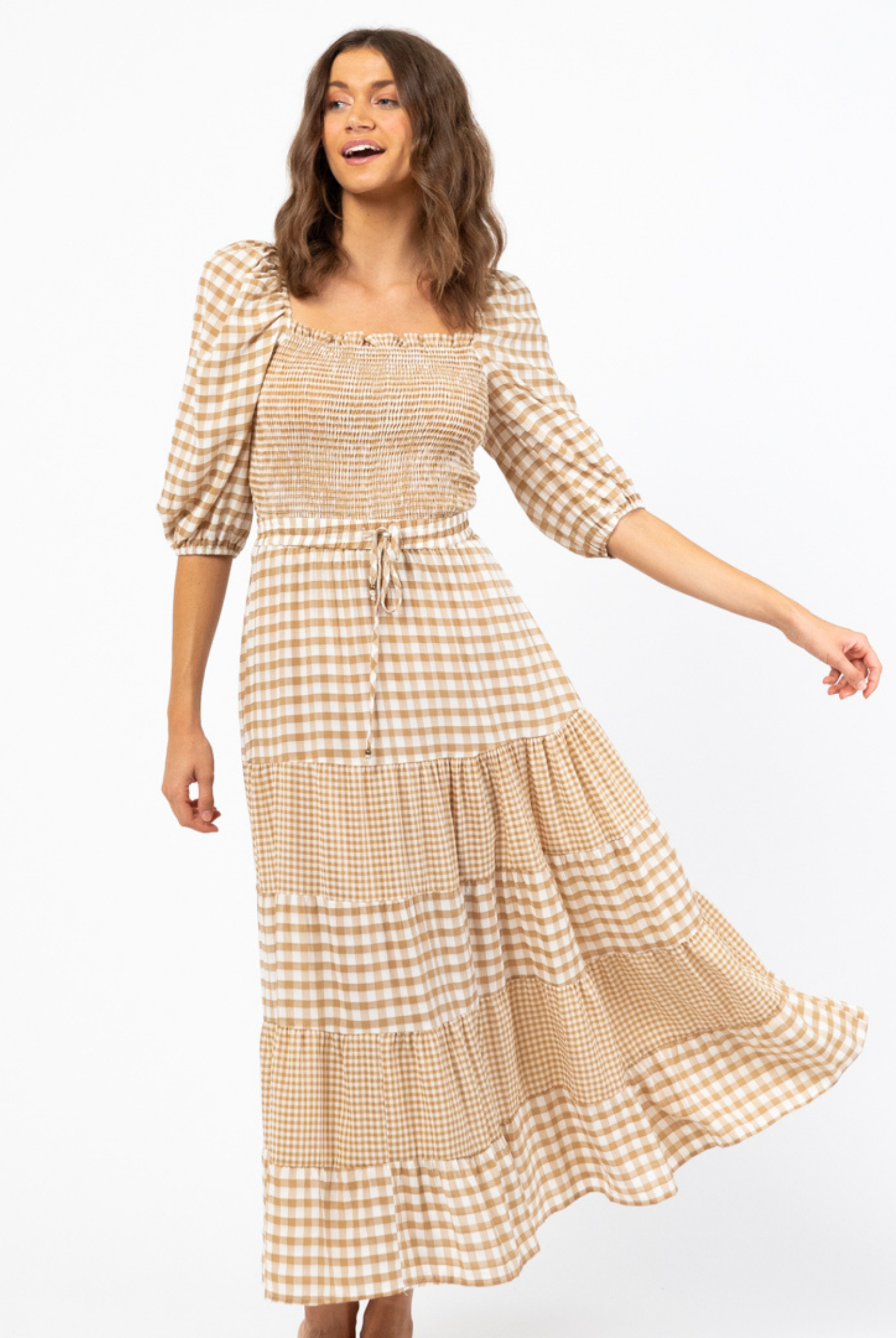 Model with brown hair wearing a gingham check maxi skirt with tie waistband