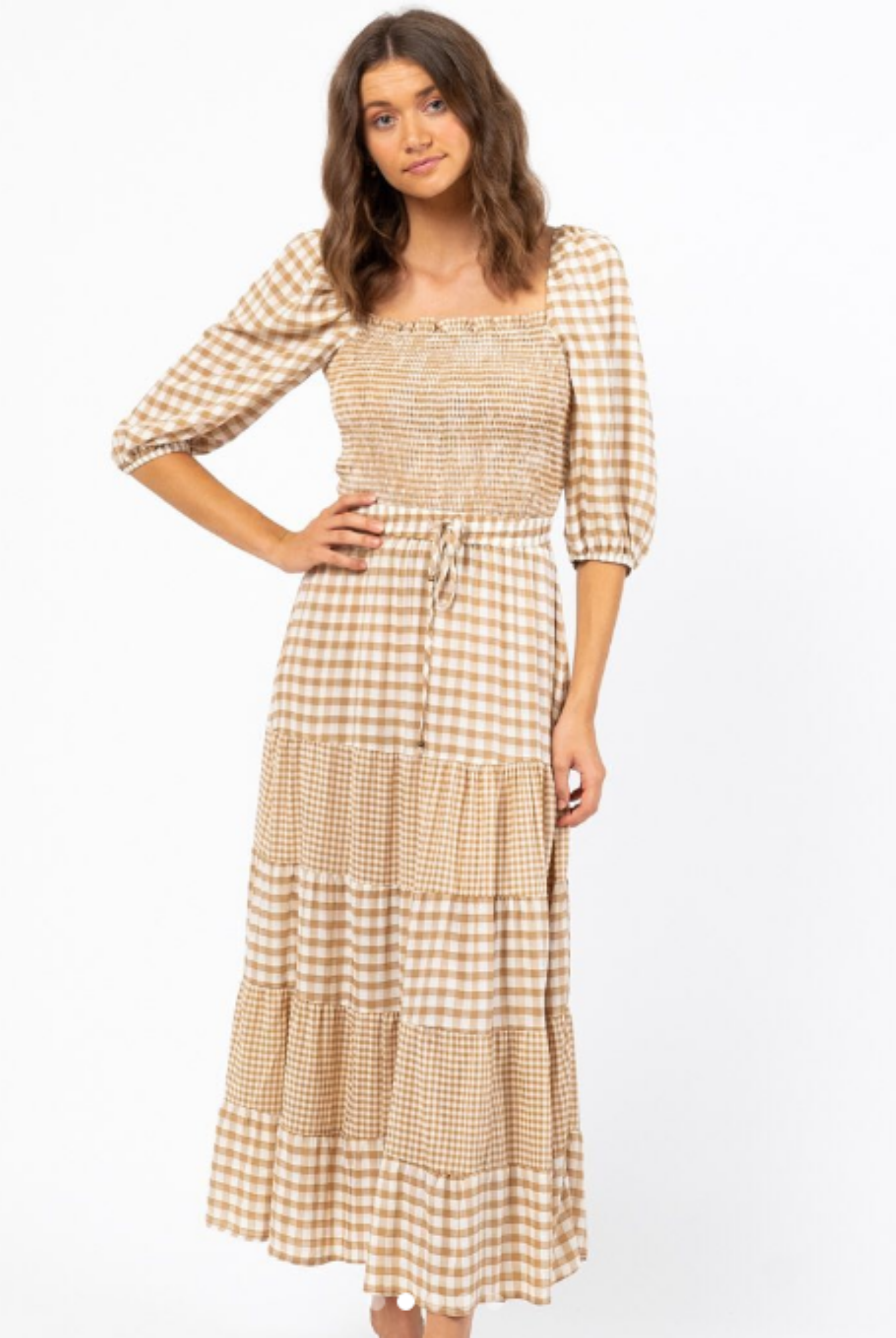 Model with brown hair wearing a gingham check maxi skirt with tie waistband