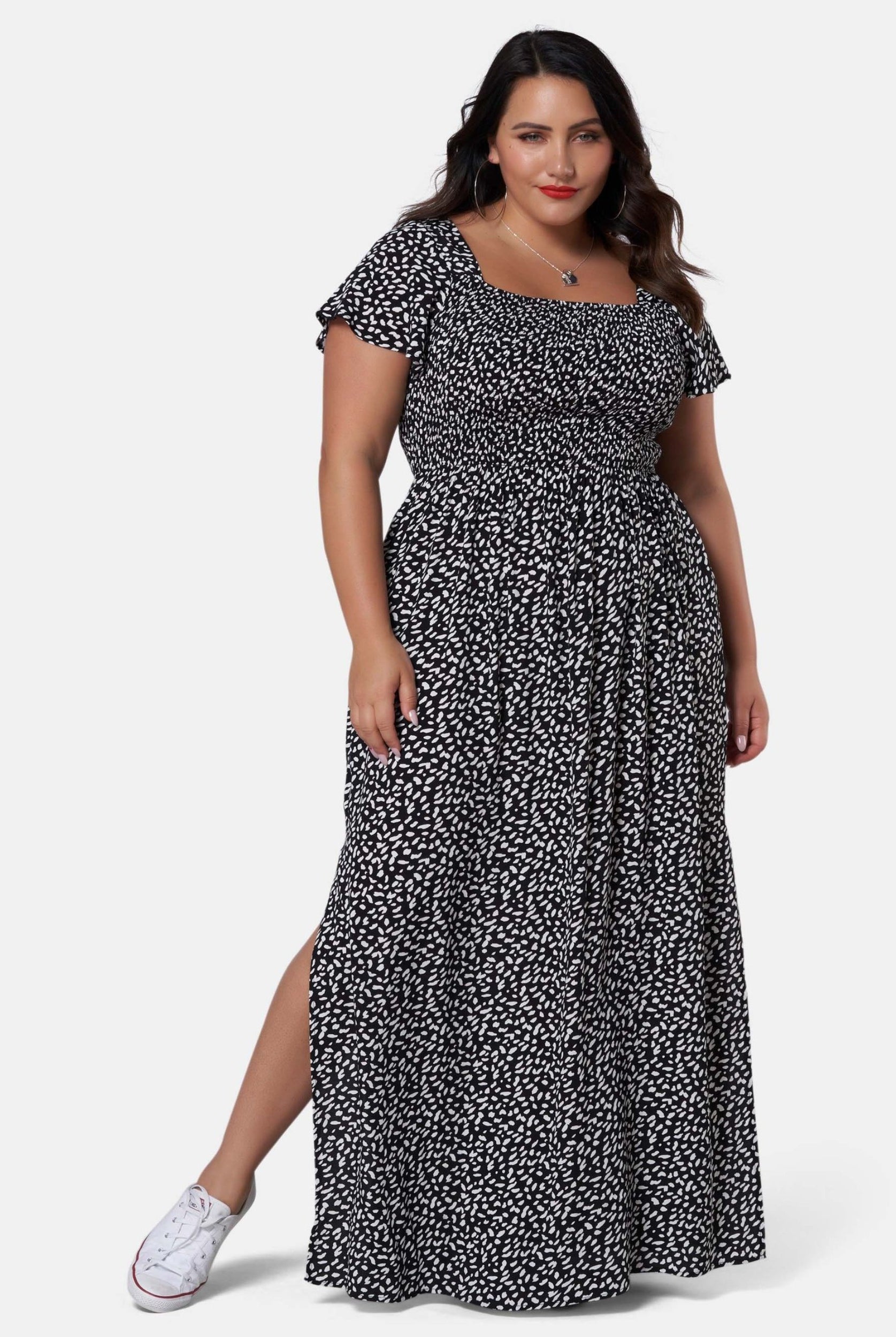 Woman wearing black and white print maxi dress