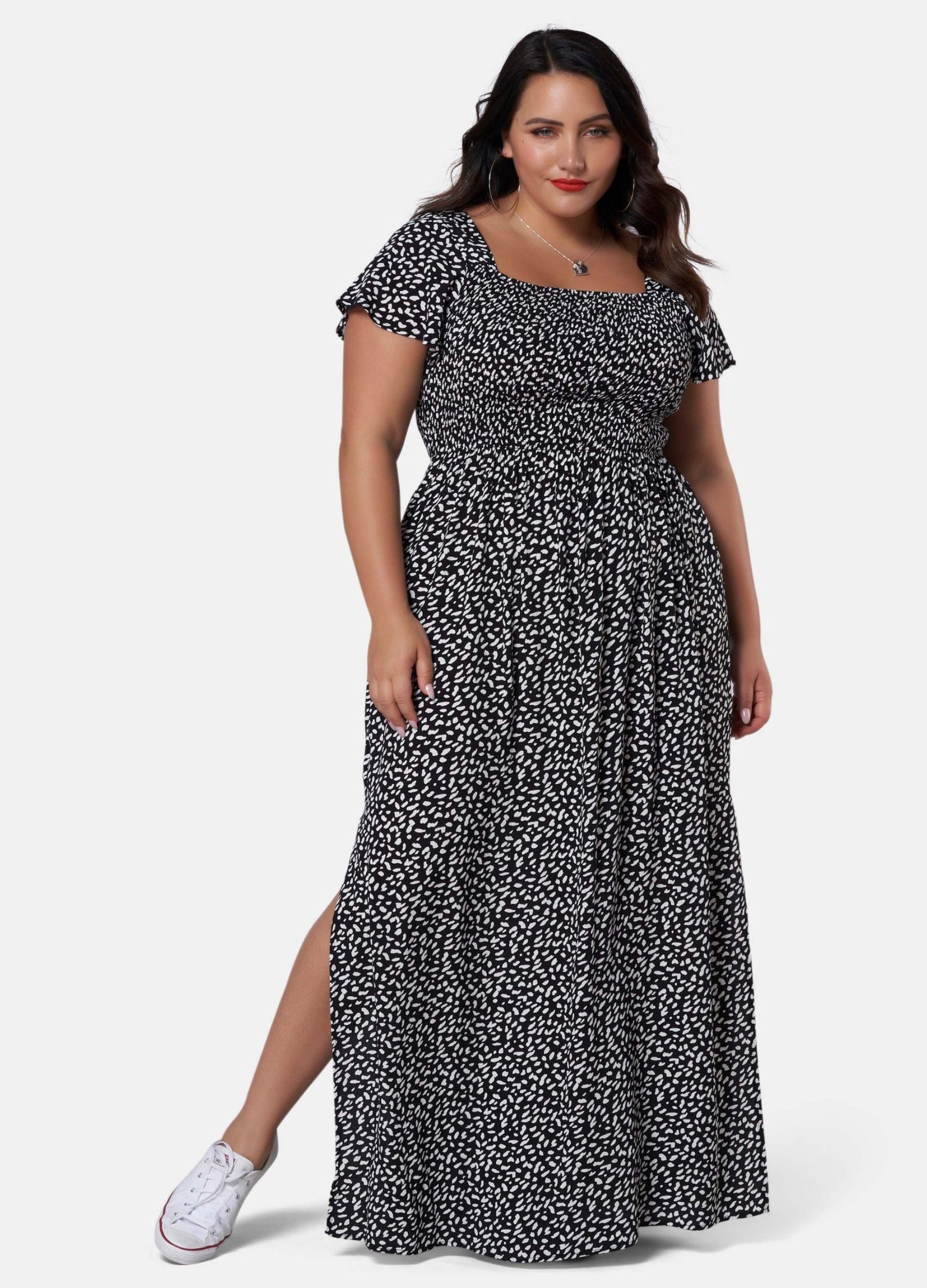 Woman wearing black and white print maxi dress