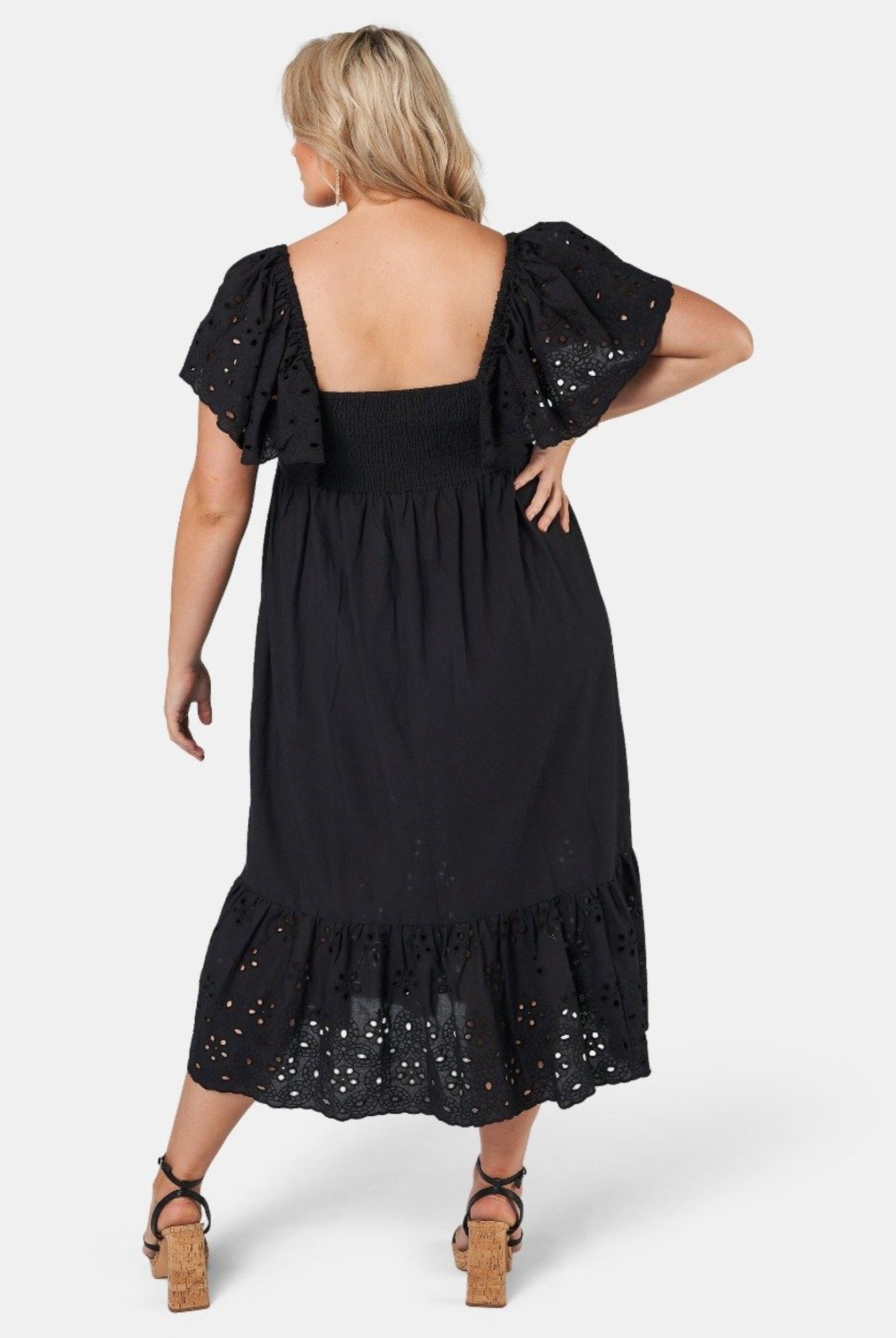 Blonde model wearing black cotton midi dress