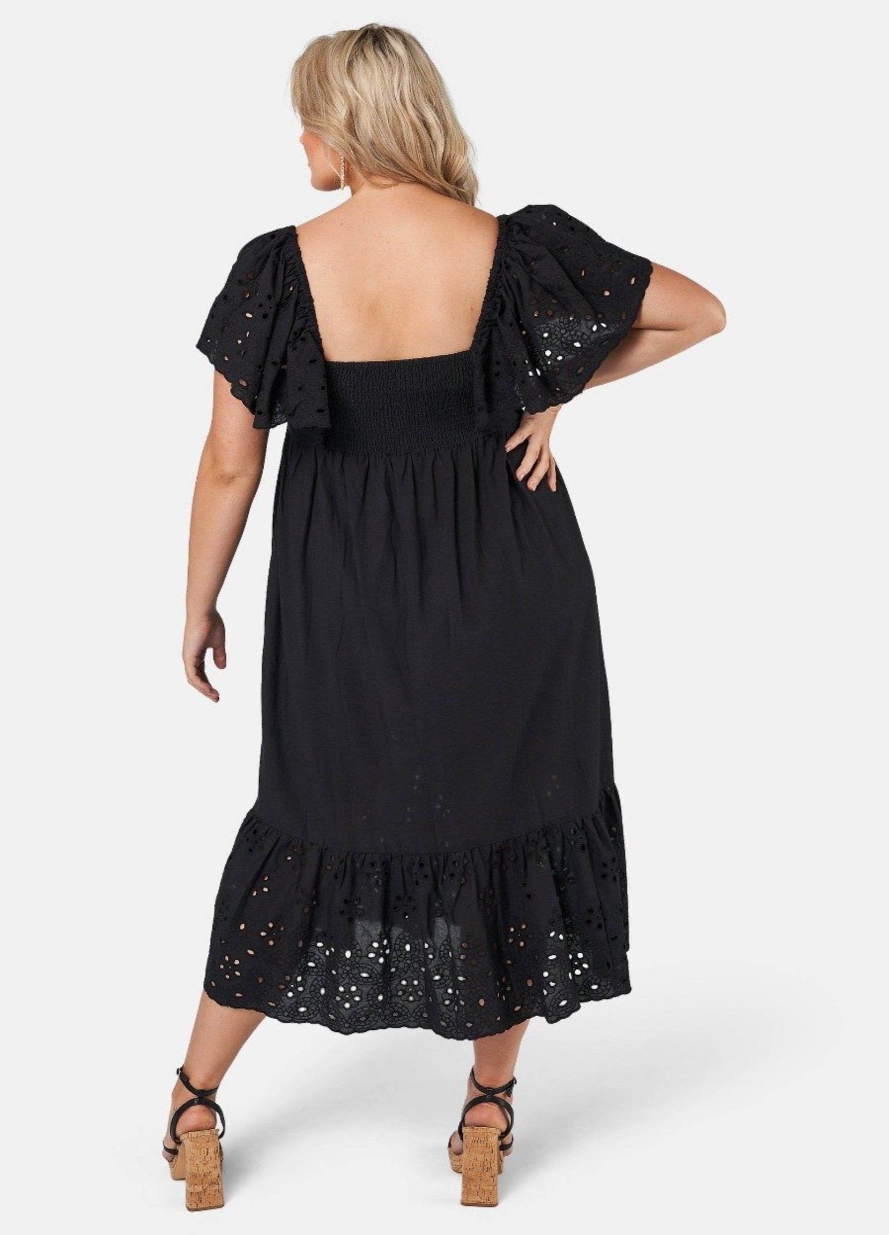 Blonde model wearing black cotton midi dress