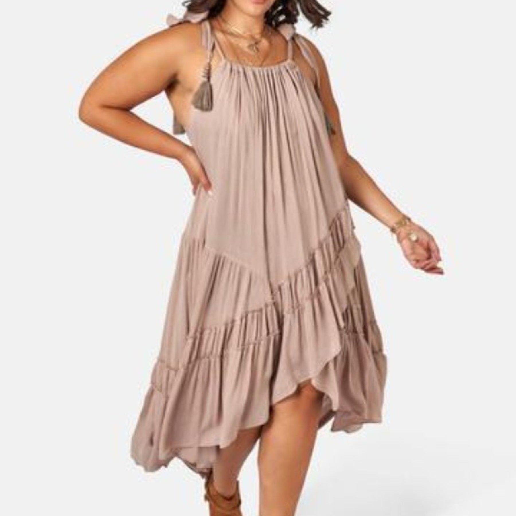 Model wearing nude maxi dress with asymmetric hemline
