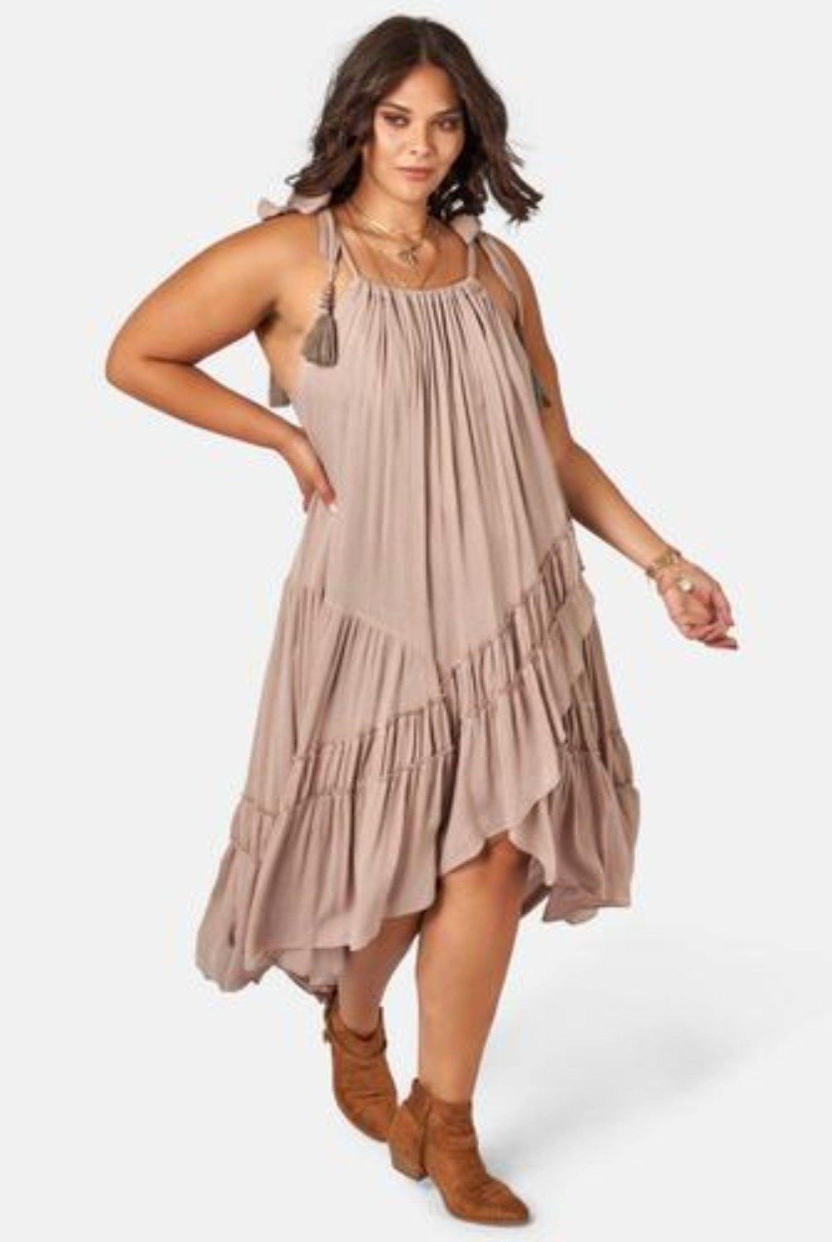 Model wearing nude maxi dress with asymmetric hemline