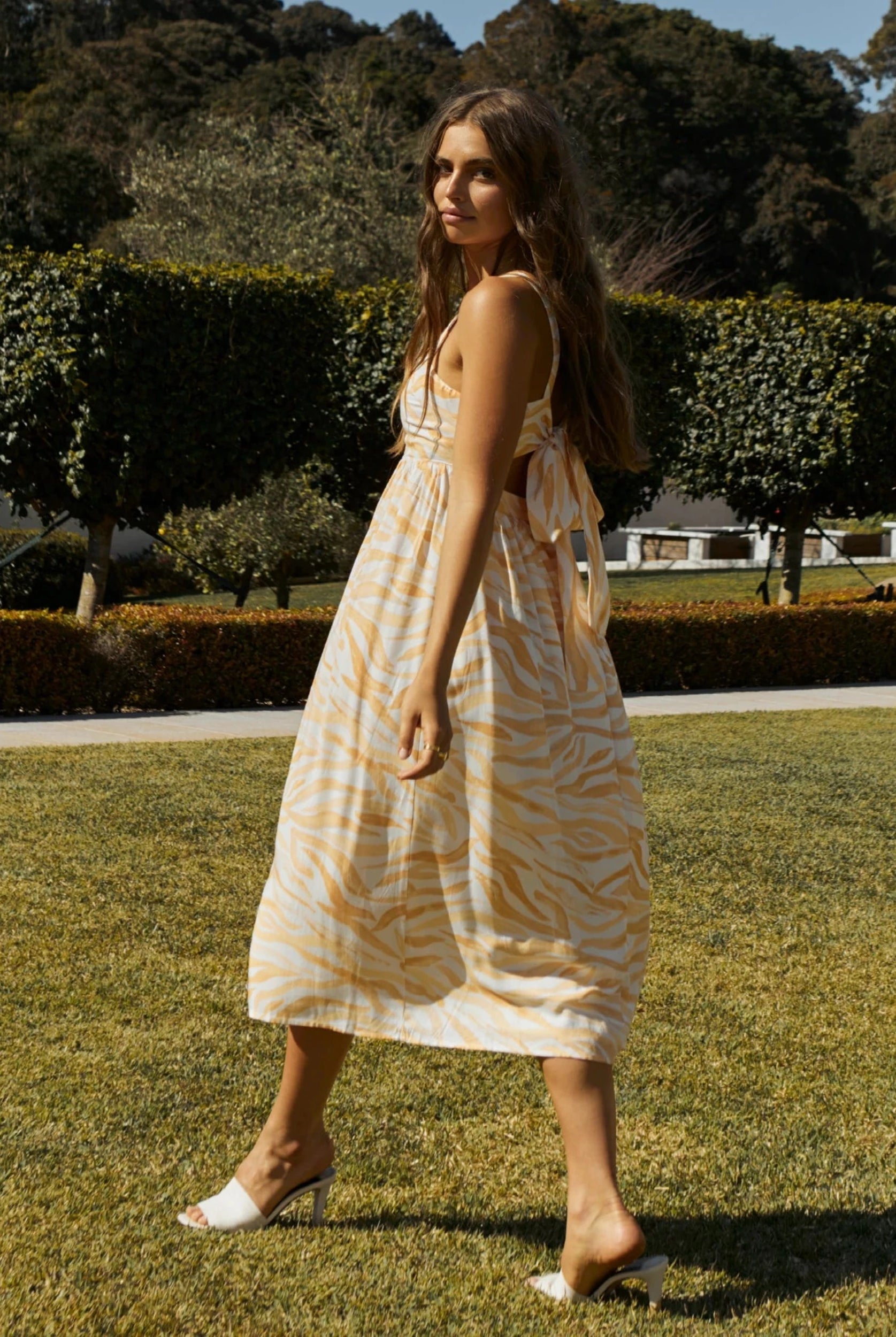 Model wearing the orange wave print dress