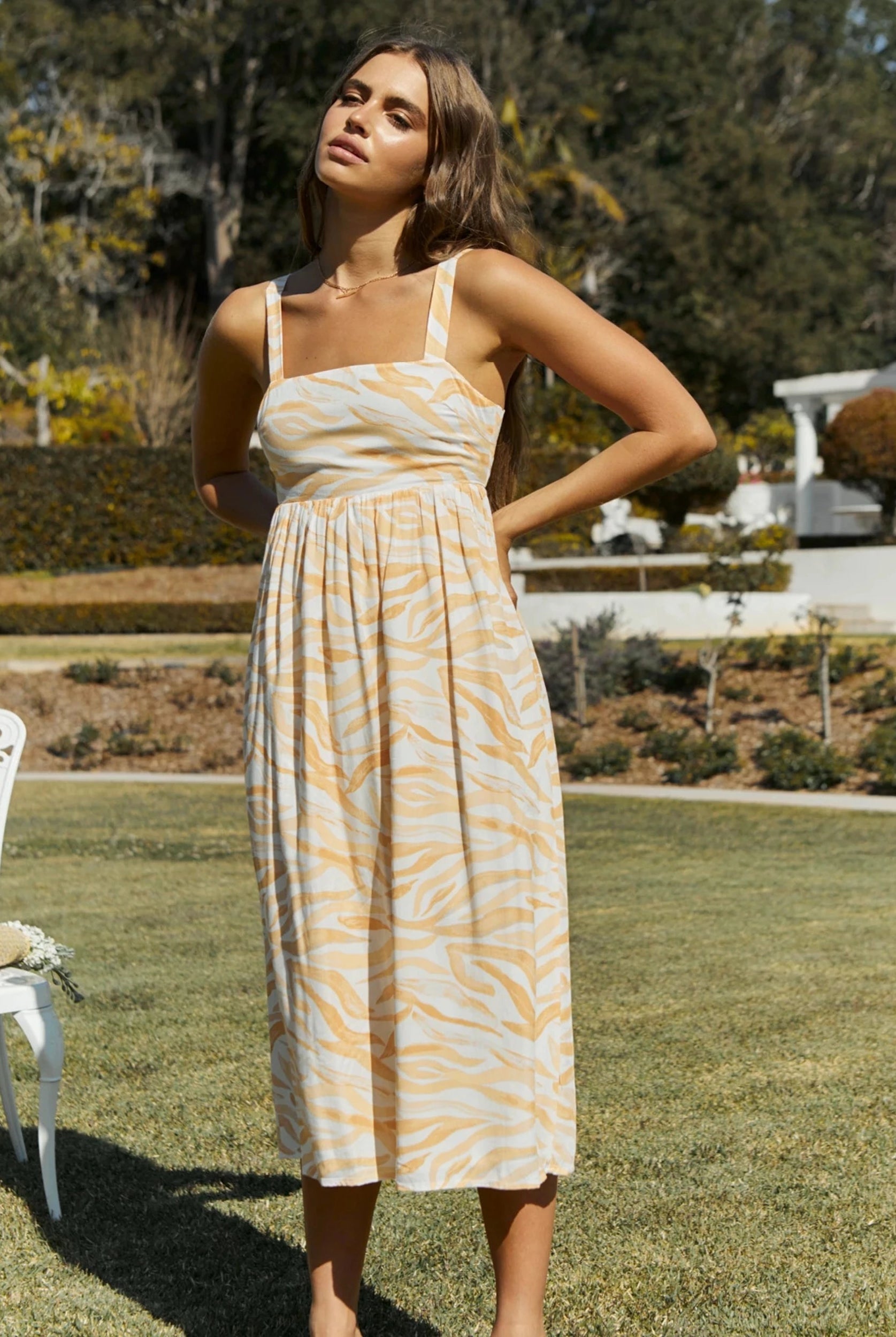 Model wearing the orange wave print dress