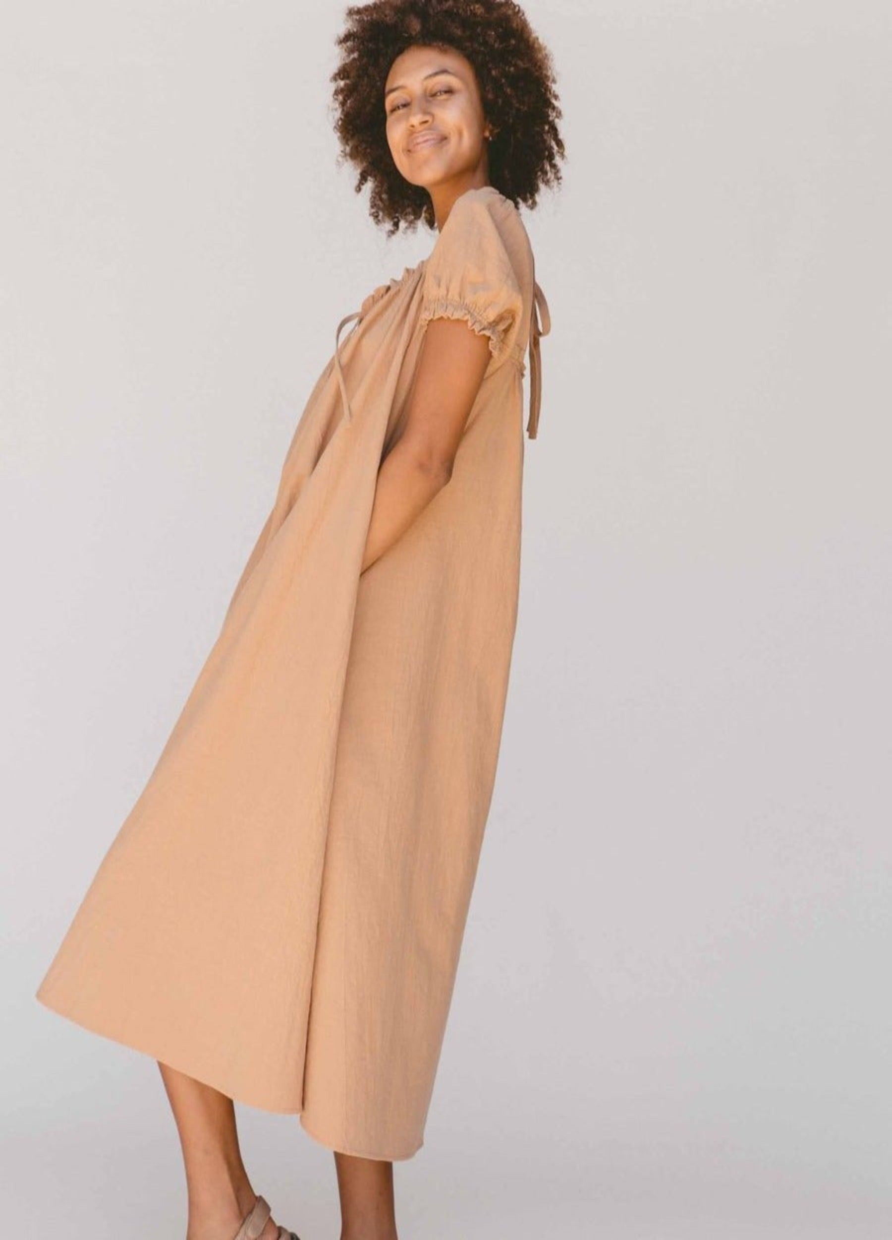 Model wearing a beige midi dress