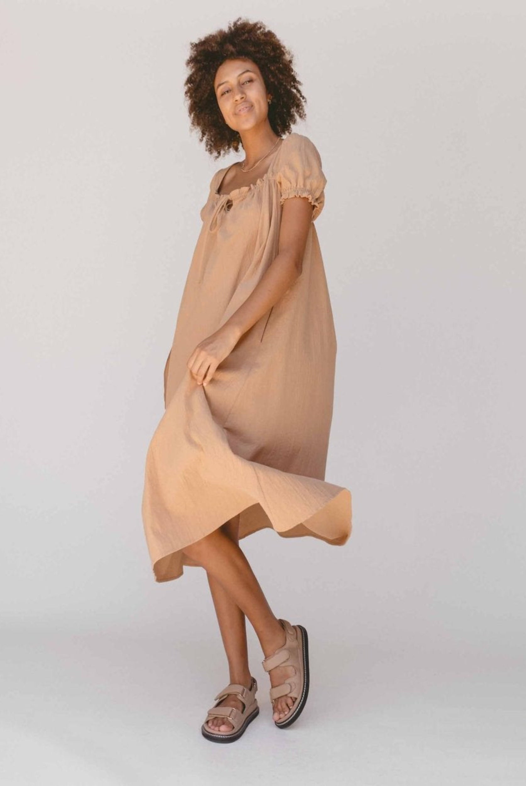 Model wearing beige midi dress