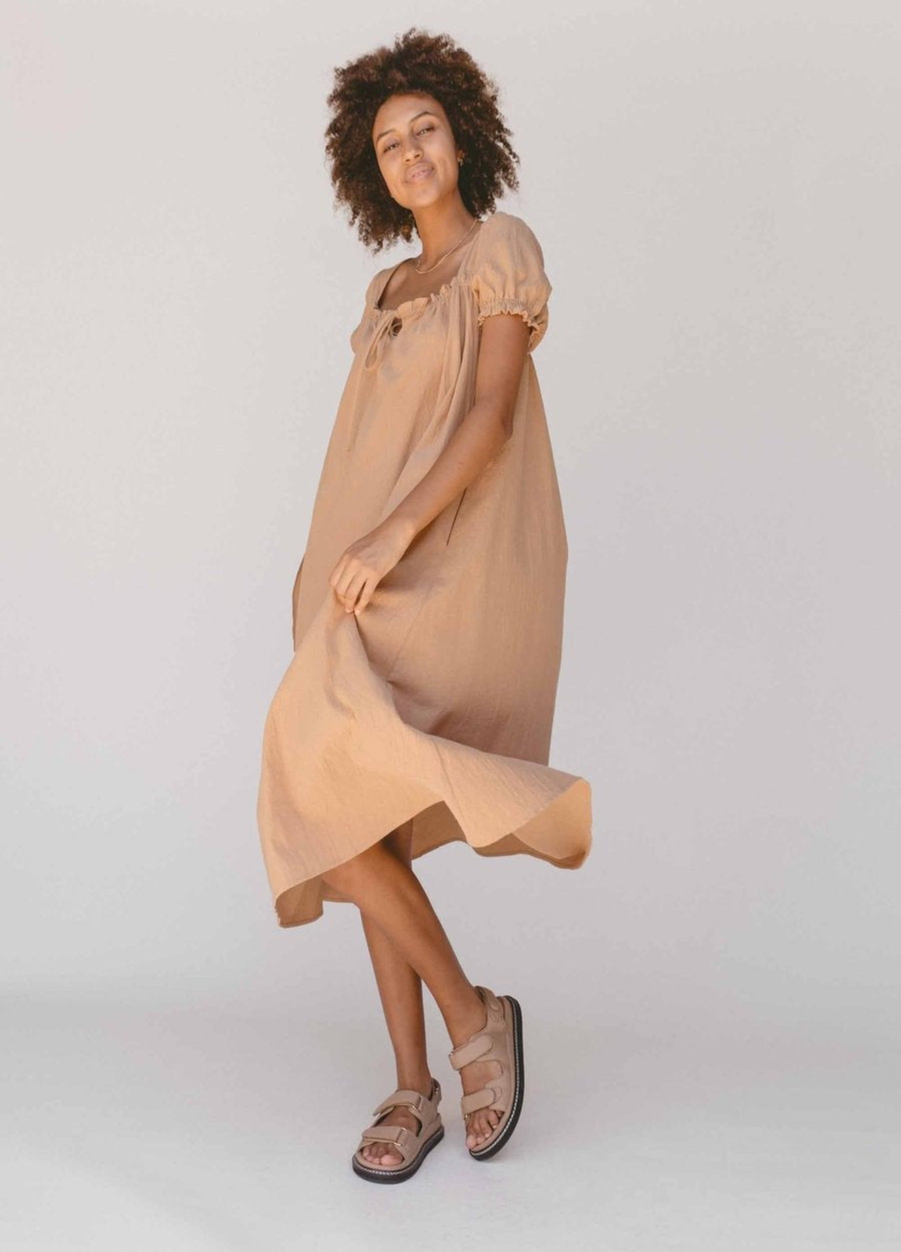 Model wearing beige midi dress