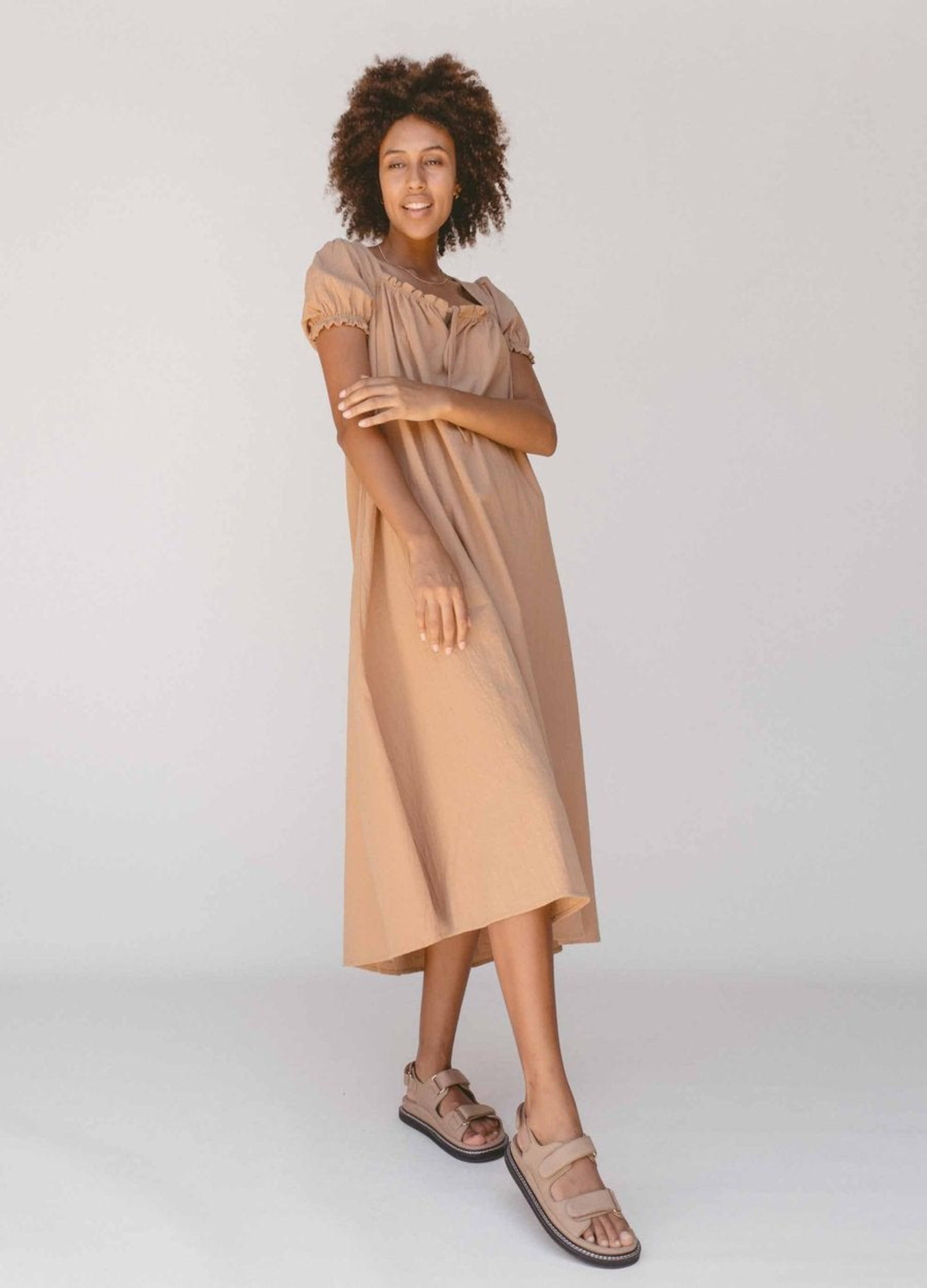 Model wearing beige colour midi dress