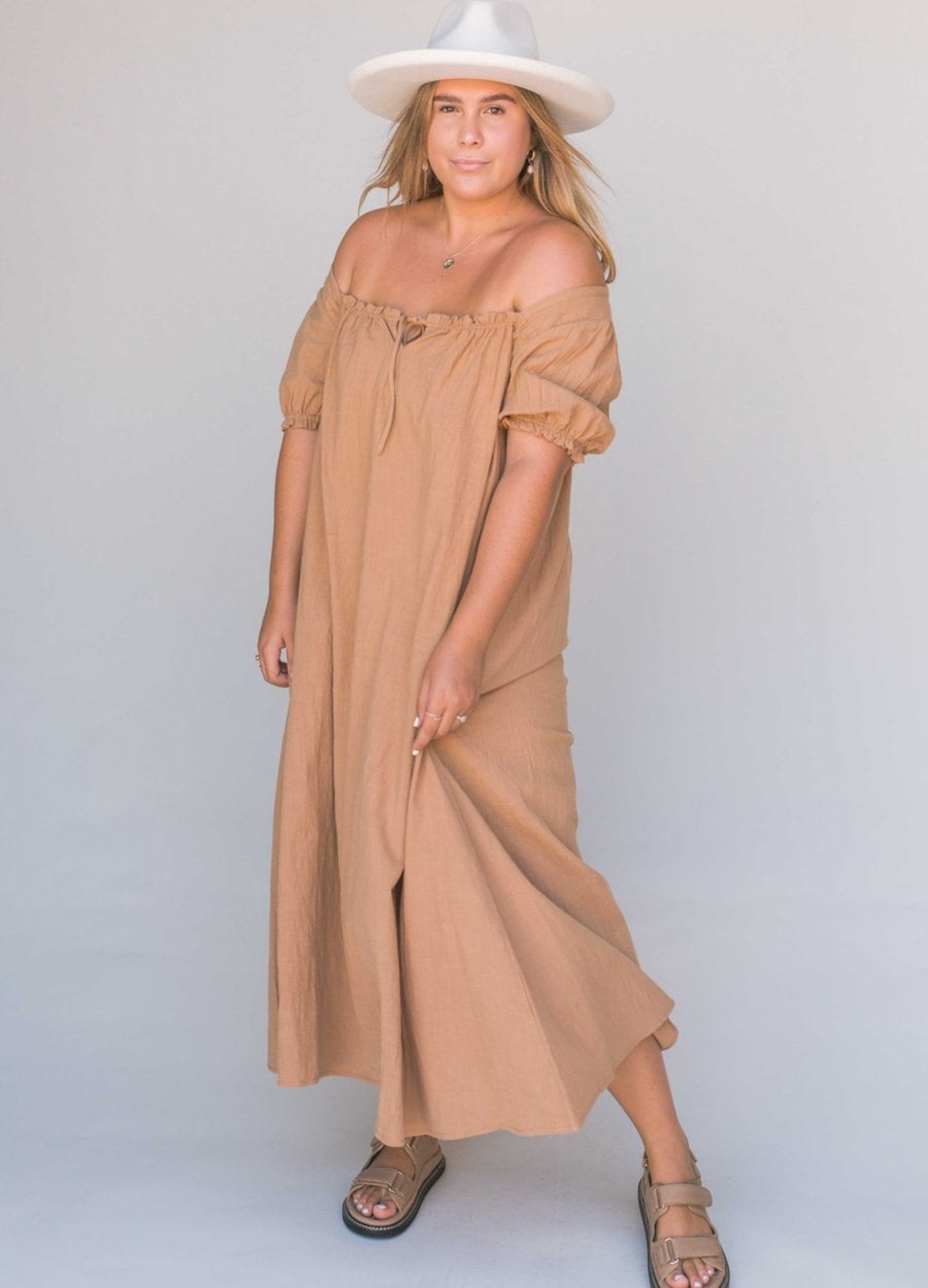 Model wearing beige midi dress
