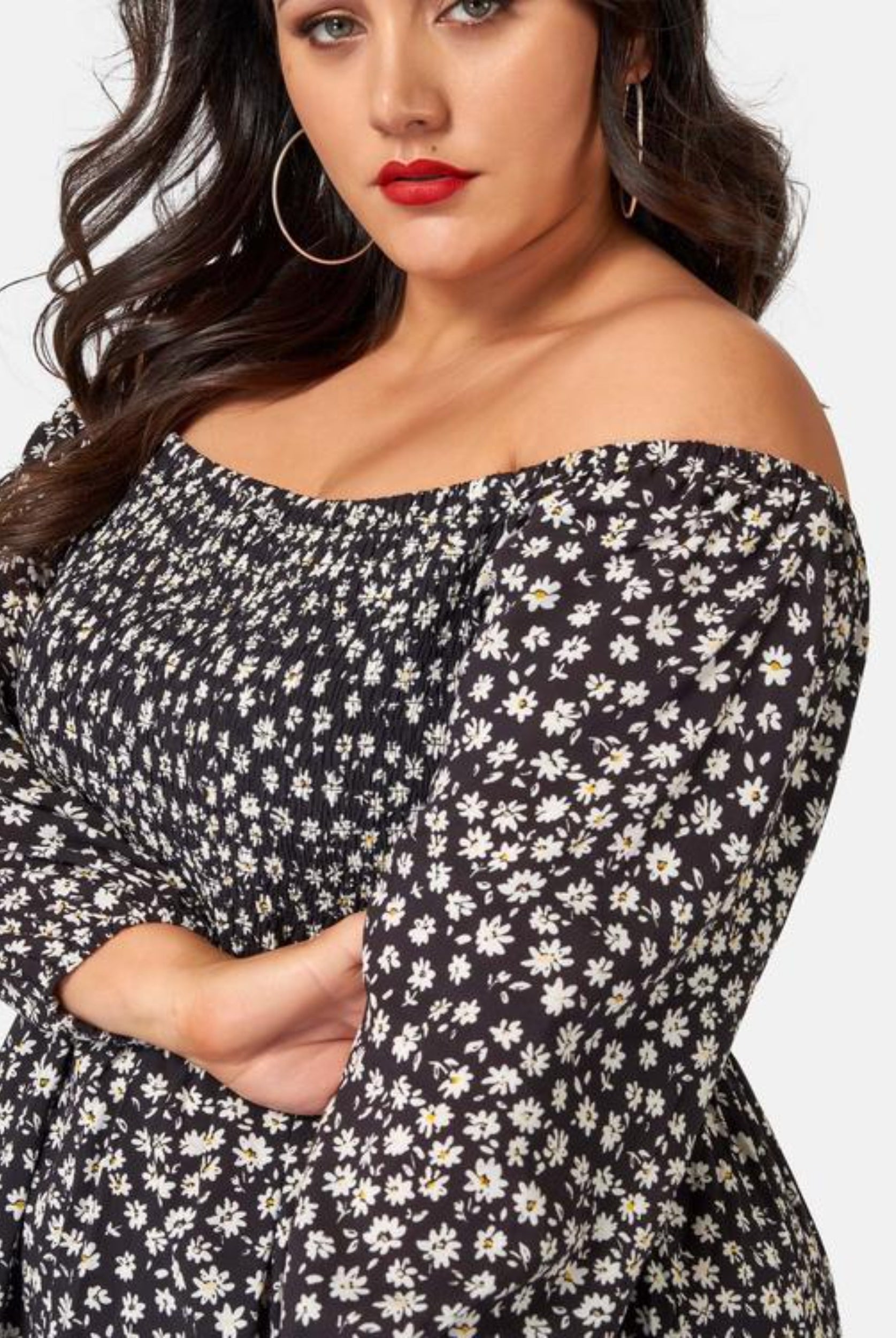 Curvy Woman wearing off shoulder floral print dress with 3/4 sleeve