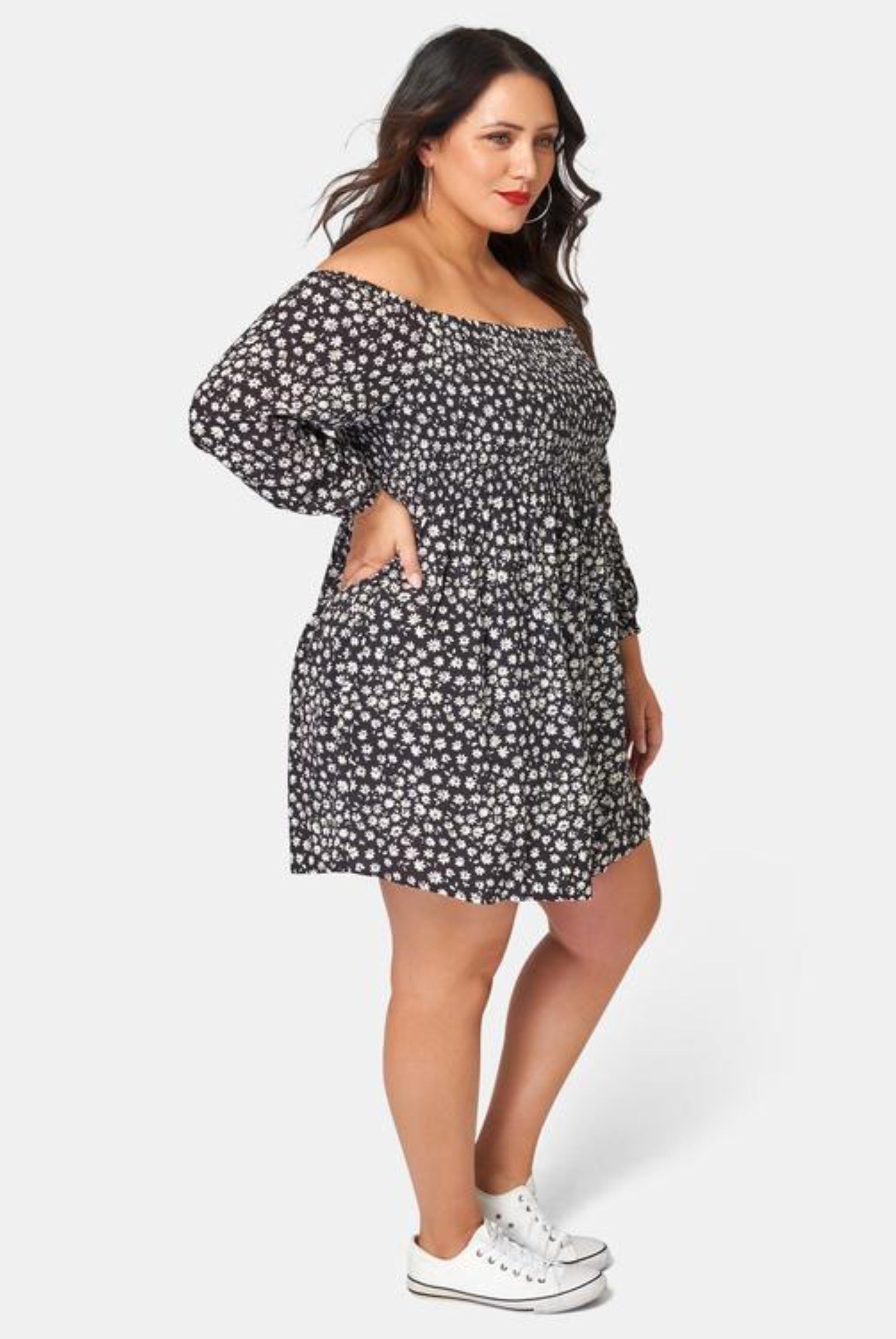 Curvy Woman wearing off shoulder floral print dress with 3/4 sleeve