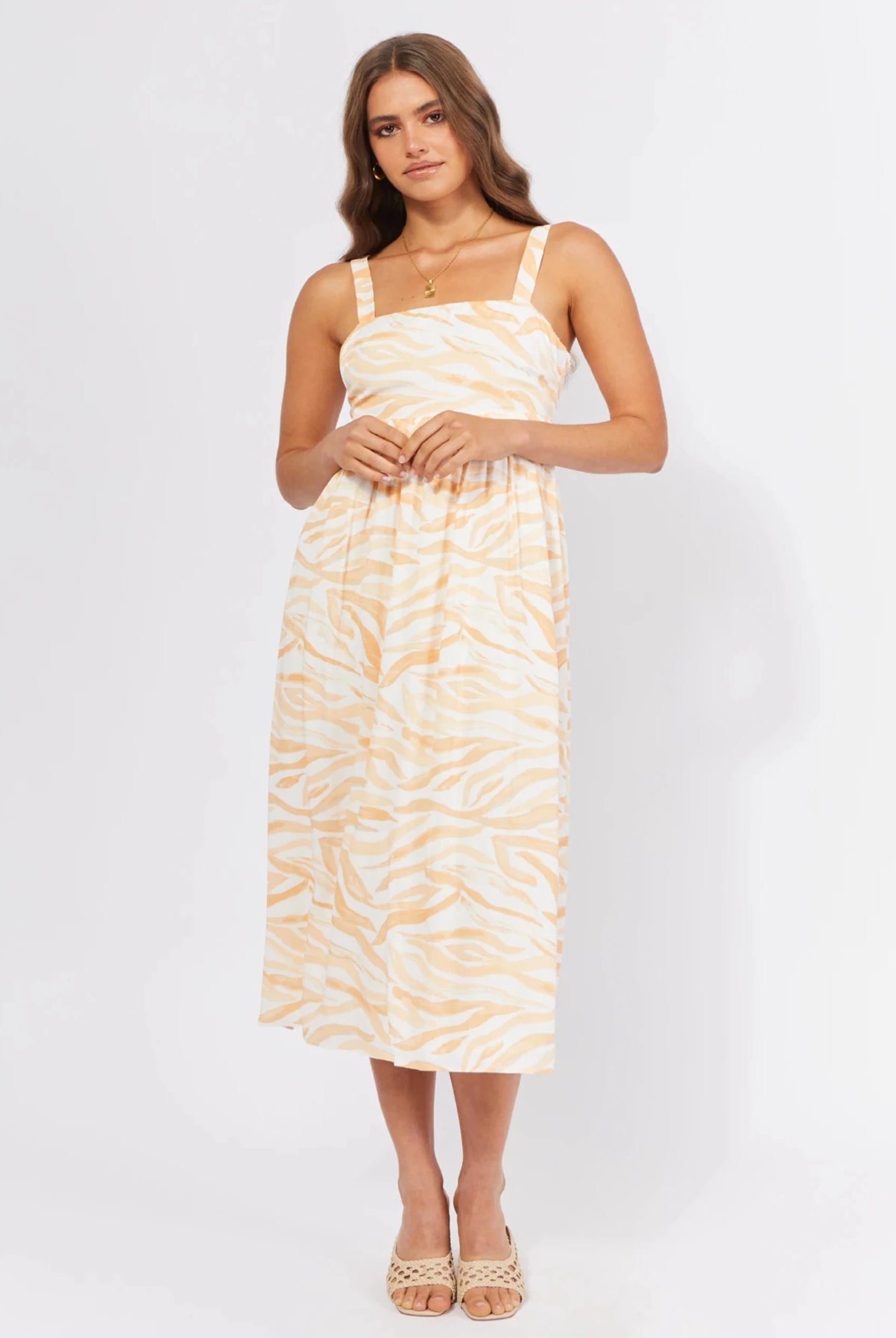 Model wearing the orange wave print dress