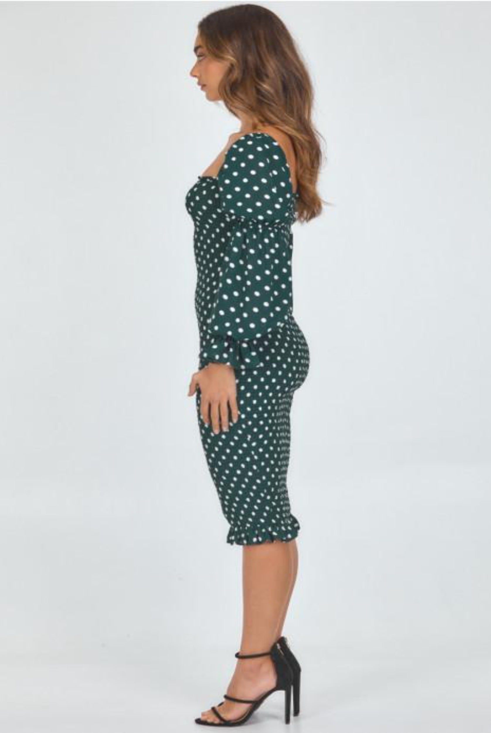 Model wearing dot print dress view from the side