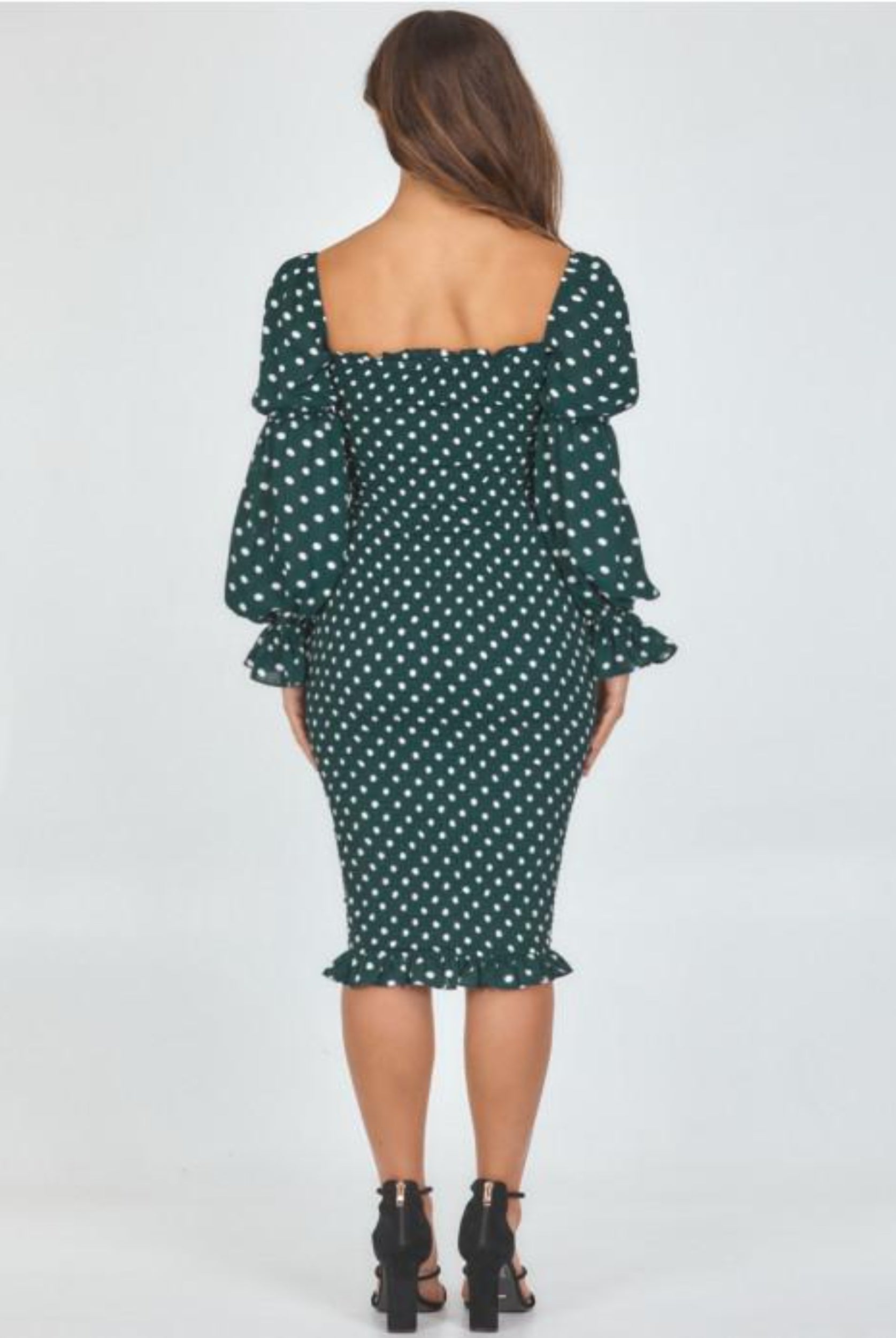 Model wearing dot print dress view from the back