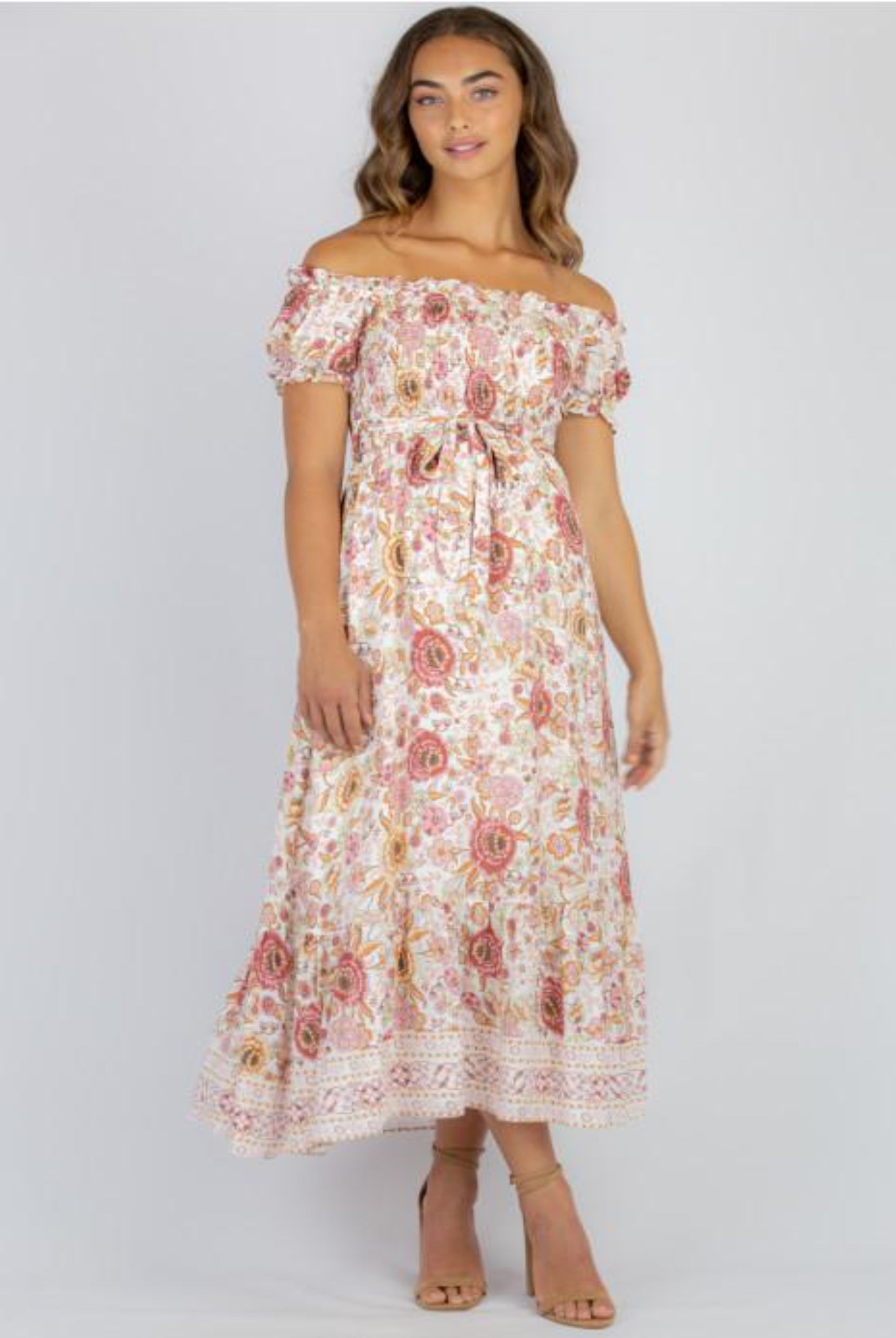 Model wearing floral maxi dress with nude colour heels