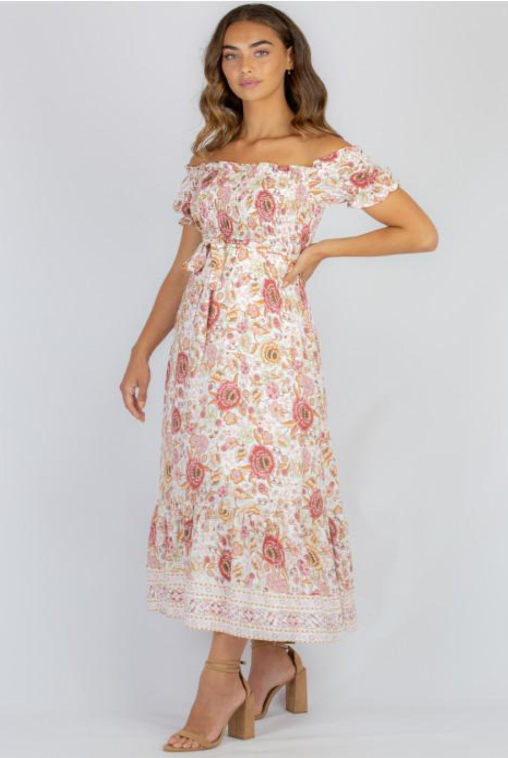 Model wearing floral maxi dress with nude colour heels