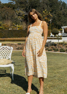 We love the back detailing on the Lexi Midi Dress, featuring a long tie and cut out. Made in our exclusive orange wave print, this dress is perfect for the events season.   Midi Dress  Square Neckline Tie back detailing with cut out Designed in Brisbane, Australia Exclusive Orange Wave Print 100% Rayon