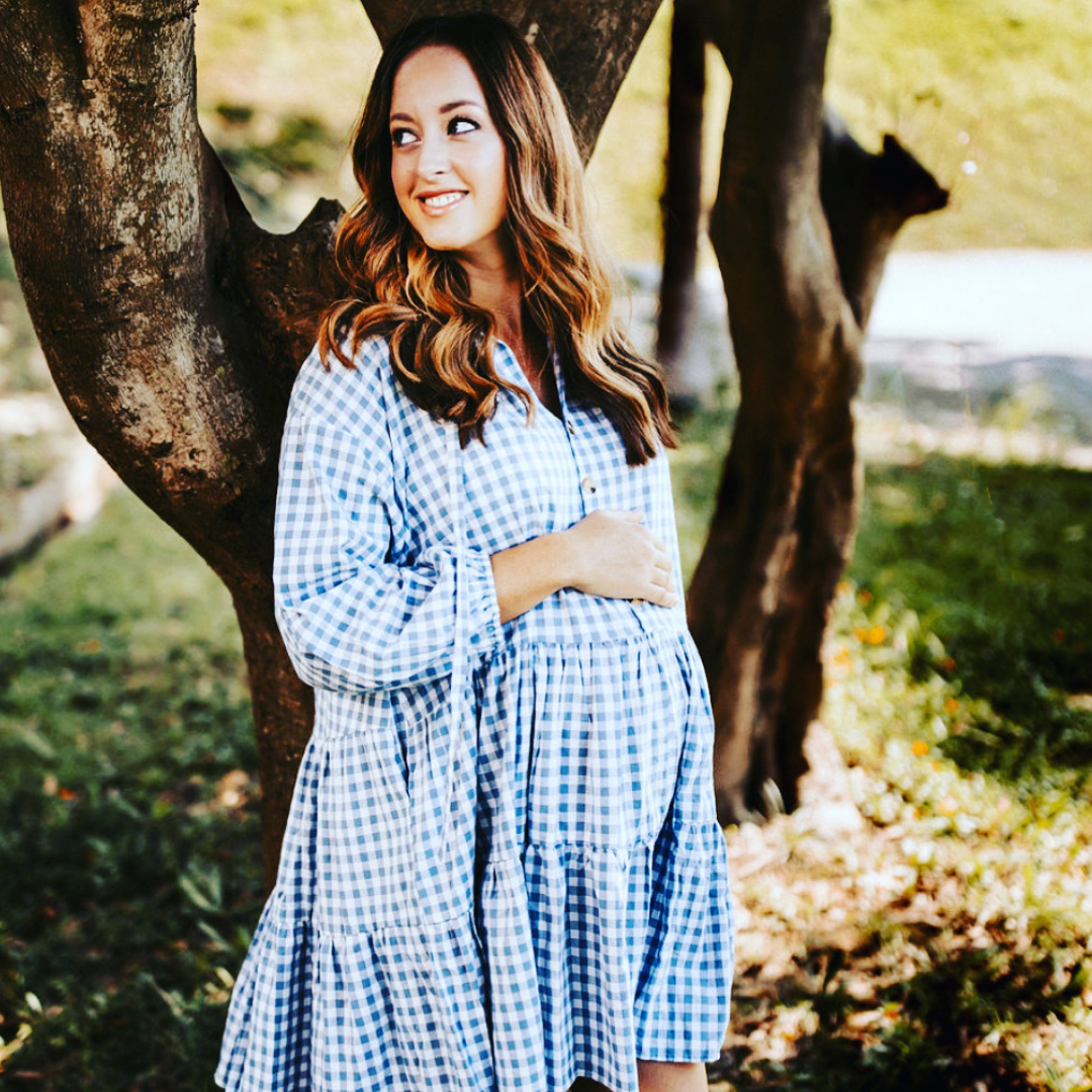 Pregnant Model wearing Avalon Smock Dress in blue gingham