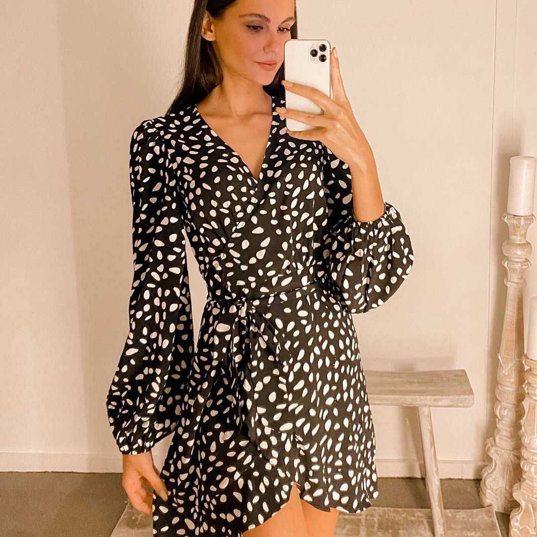 Woman wearing black and white spotty mini dress