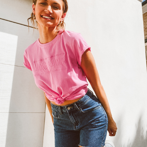 Model wearing pink tshirt and denim shorts