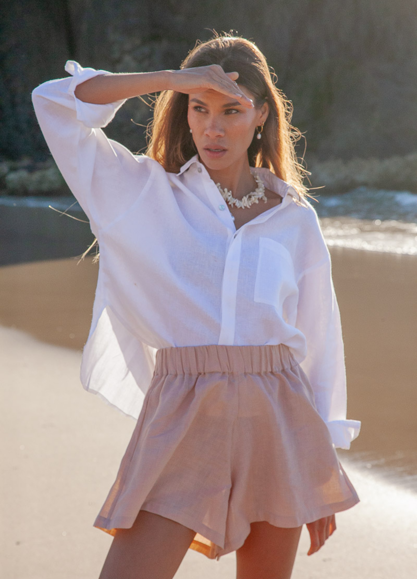 Model wearing white button up linen shirt in sustainable fabrics