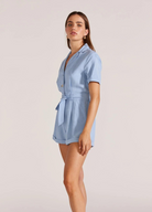 Model wearing pale blue playsuit from Staple the Label