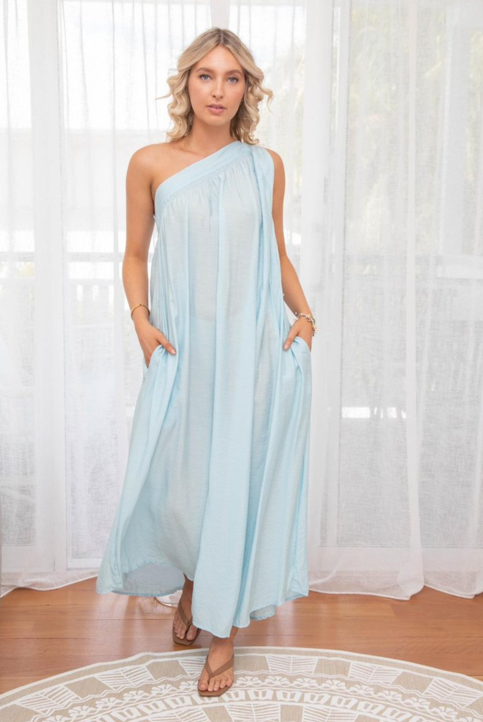 One shoulder baby blue dress in crease resistant fabric with matching belt