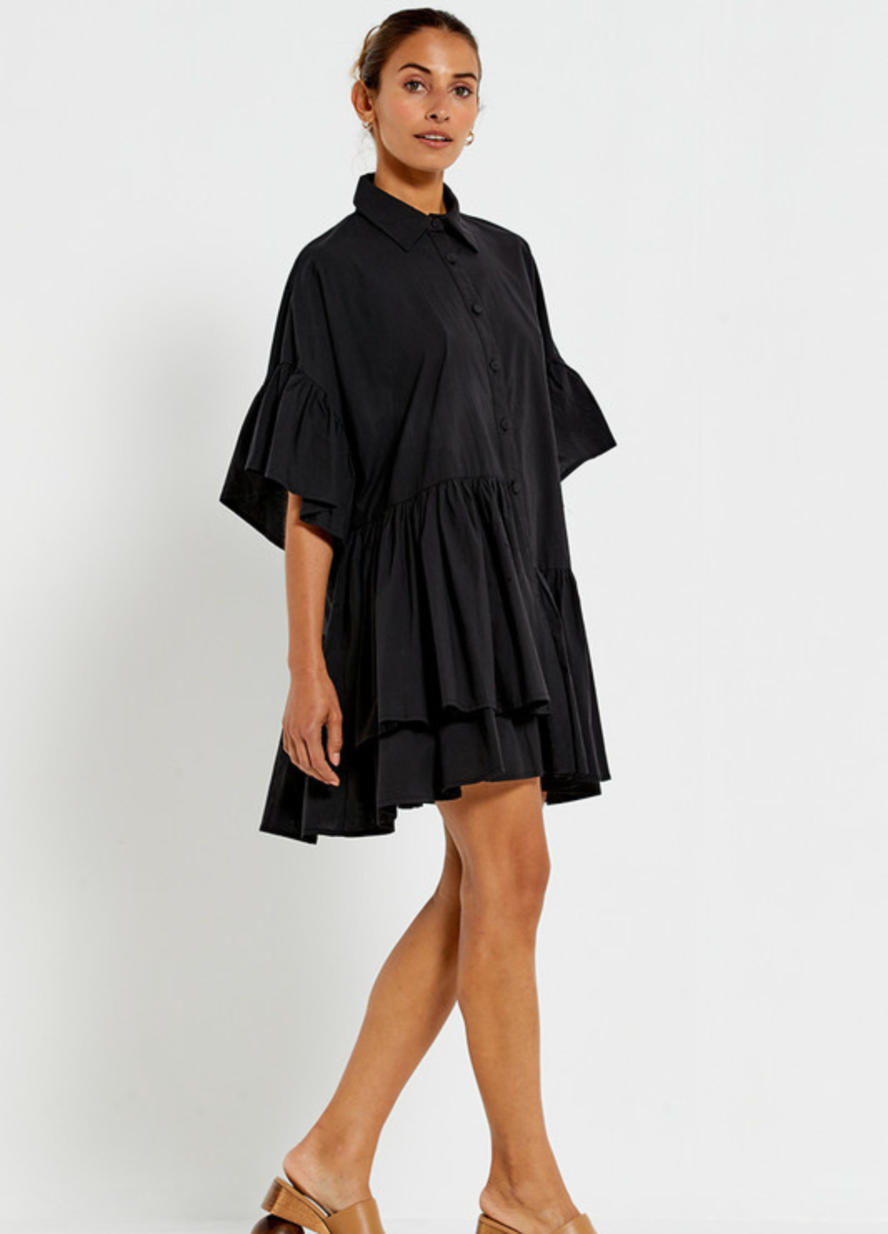 Model wearing the Bohemian Traders black Genoa Dress with button up front