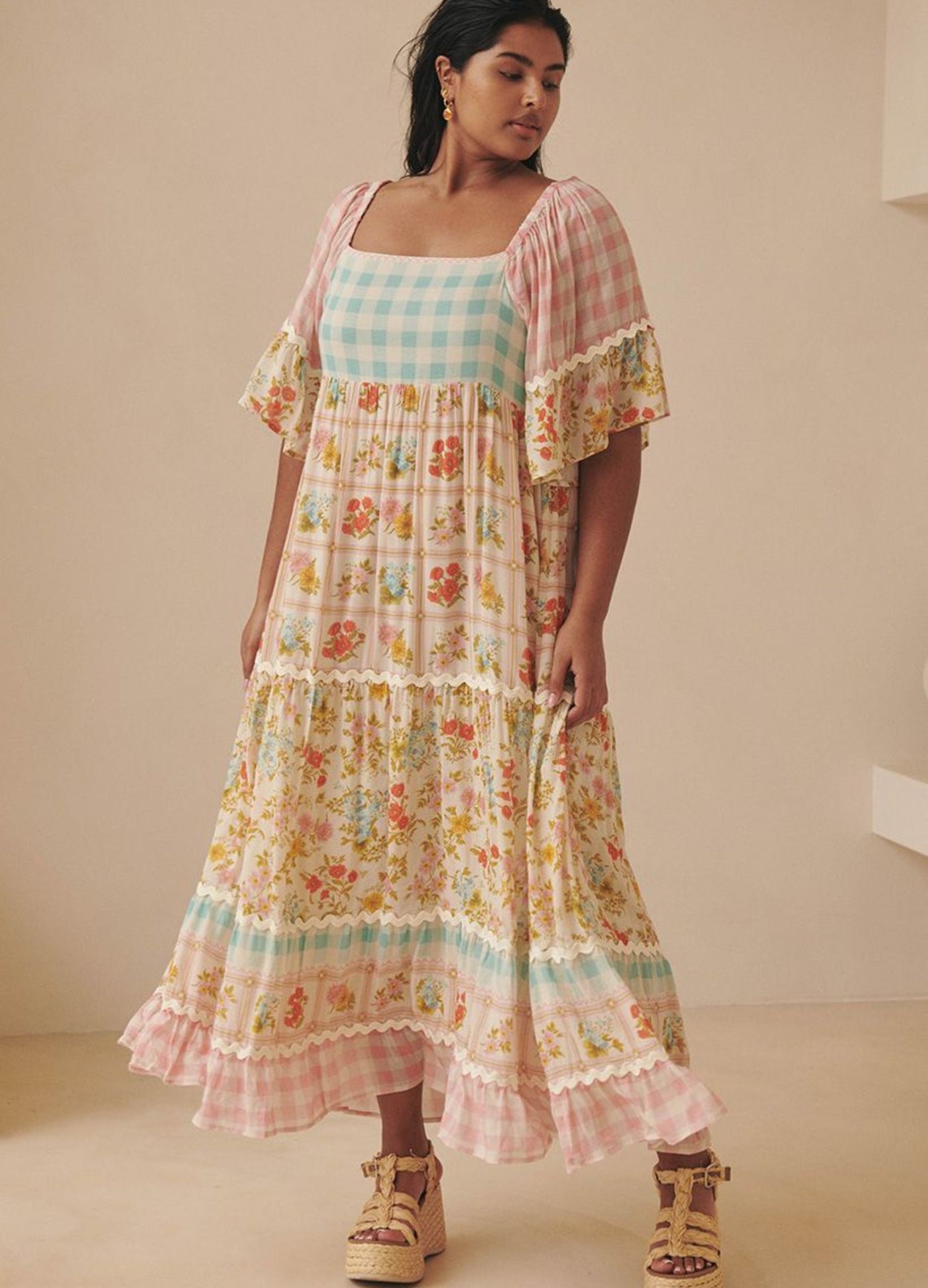 Model wearing the pastel flora gown from Spell