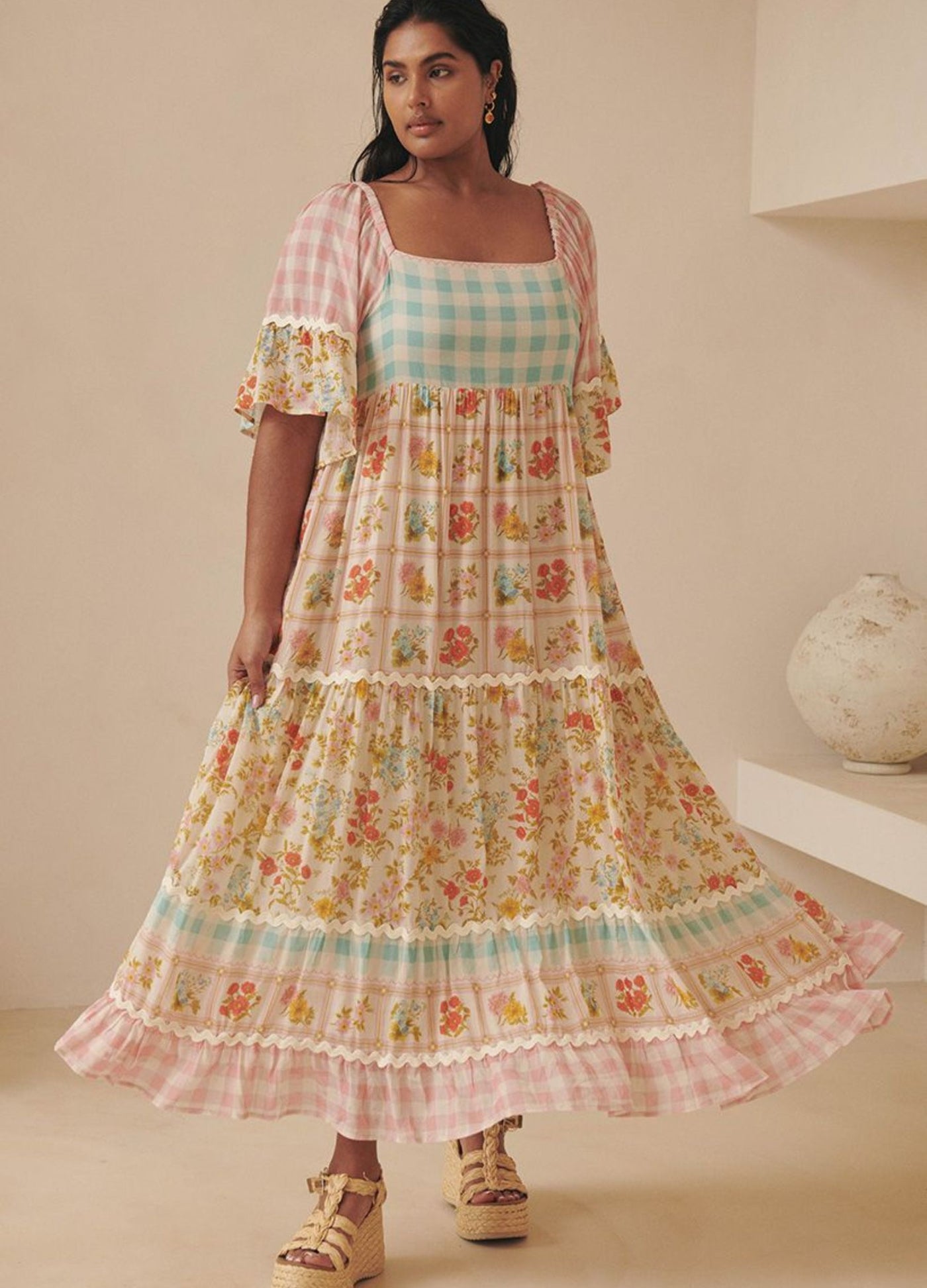 Model wearing the pastel flora gown from Spell