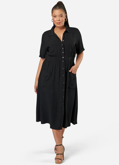 Curve model wearing a black shirt dress