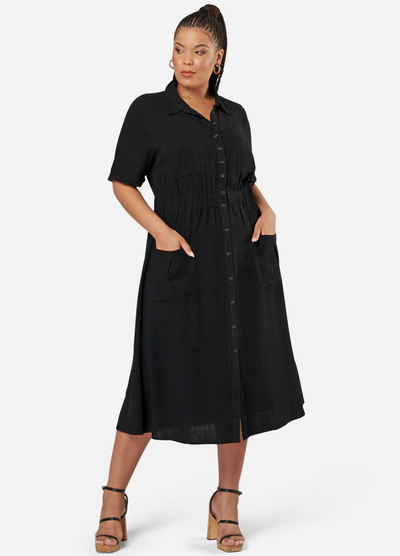 Curve model wearing a black shirt dress