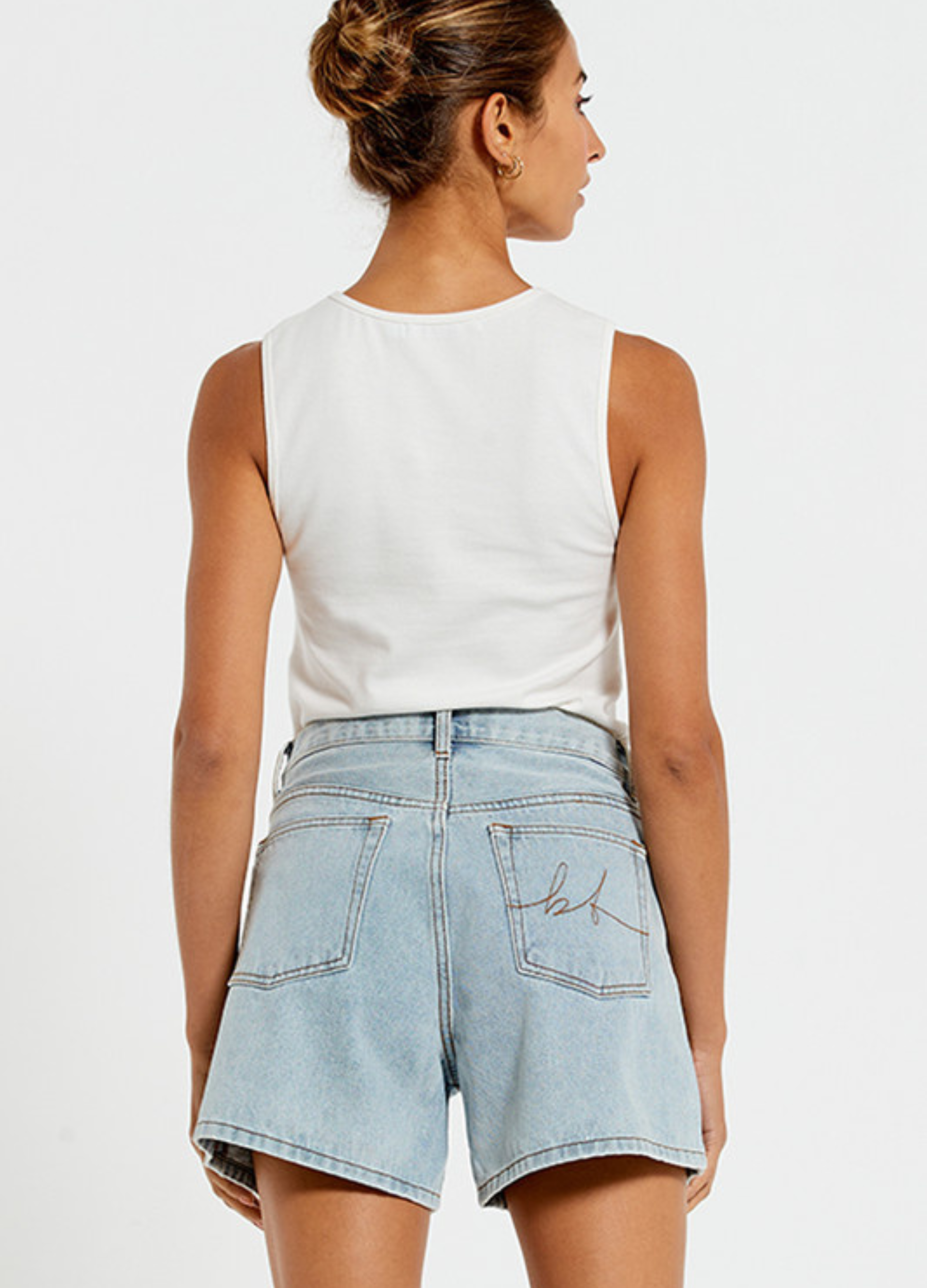 Model wearing the Bohemian Traders Mid Thigh ice wash short