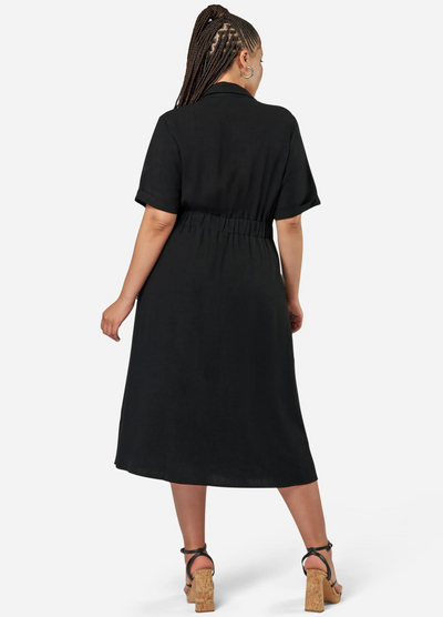 Curve model wearing a black shirt dress