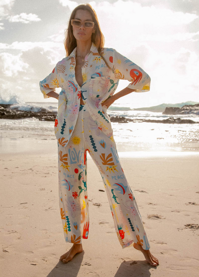 Model wearing the love art peace print pants from Palm Collective