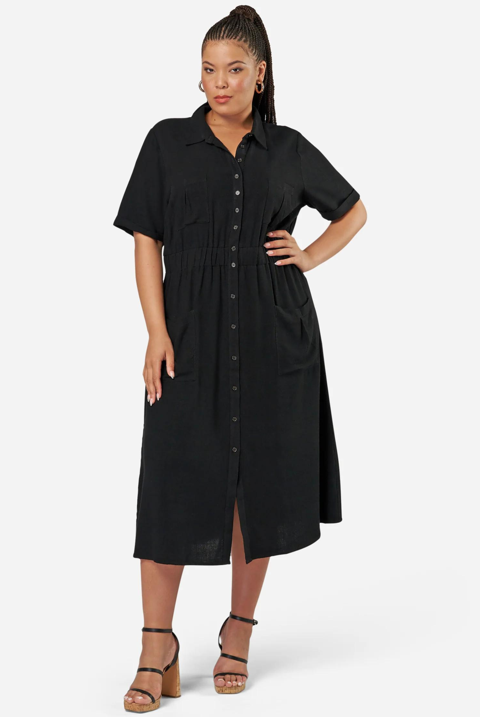 Curve model wearing a black shirt dress